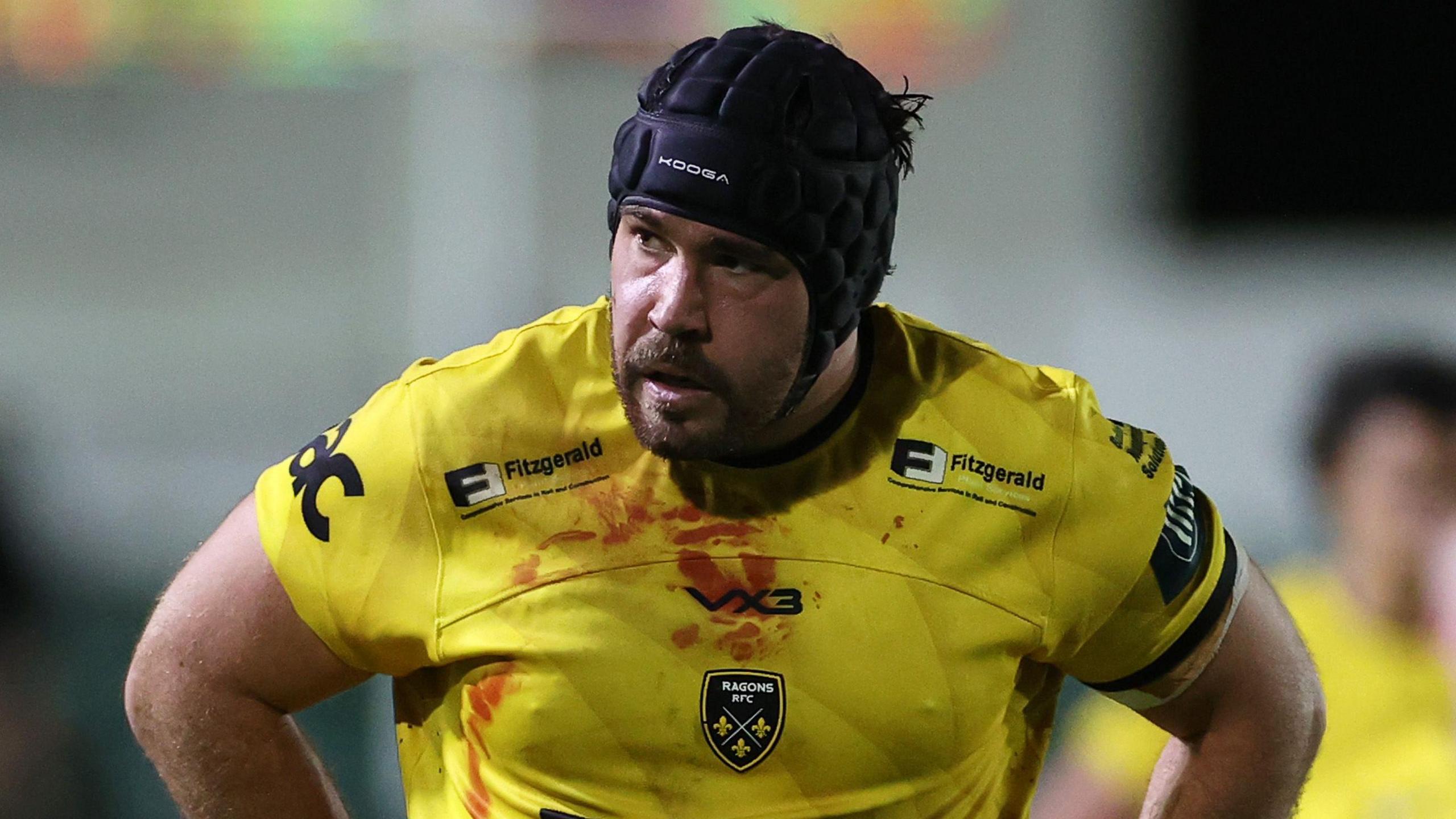 Dragons prop Robert Hunt has blood on his jersey as he waits at a lineout