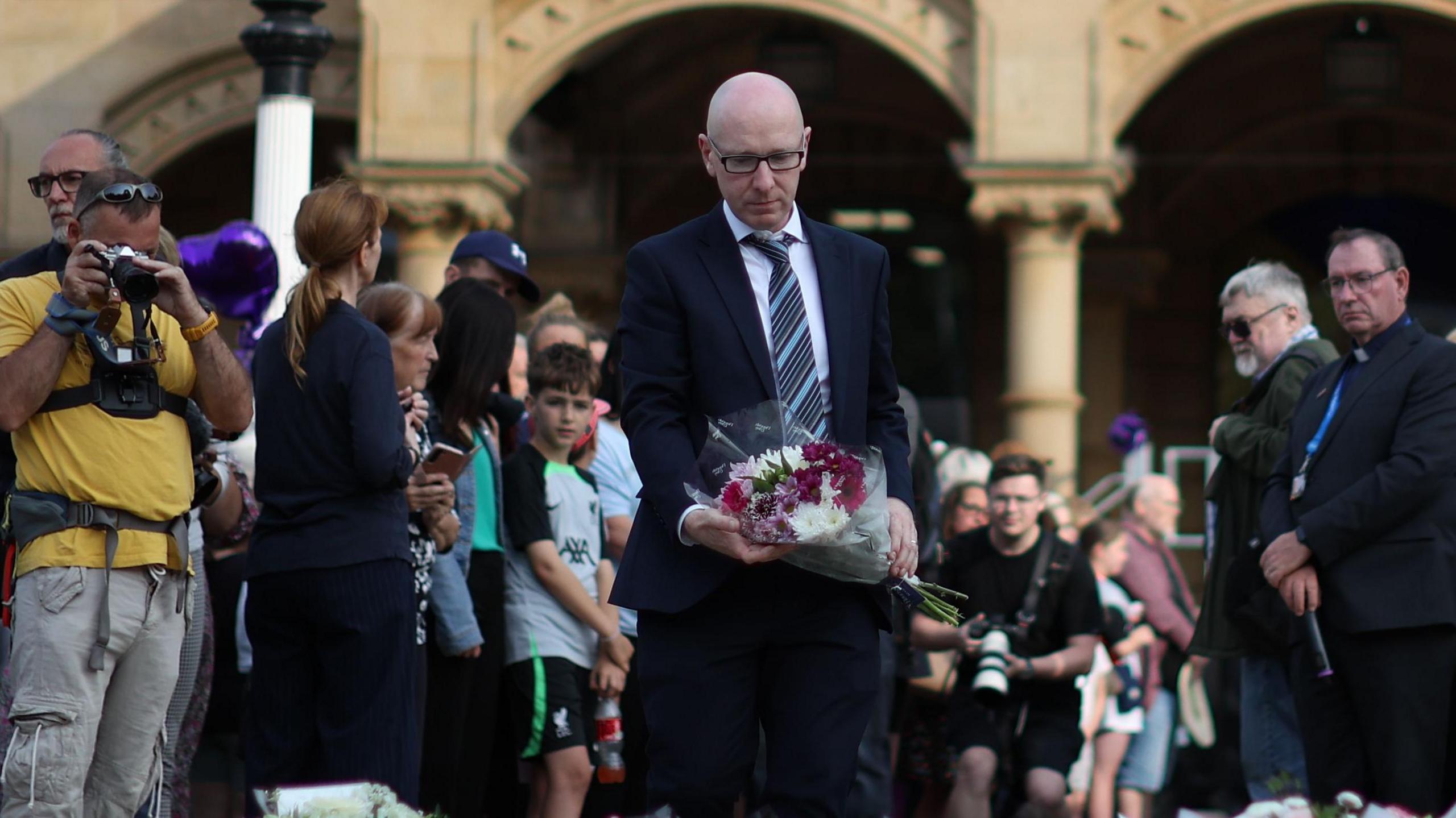 Patrick Hurley MP adds to the display of floral tributes in Southport after three little girls were murdered