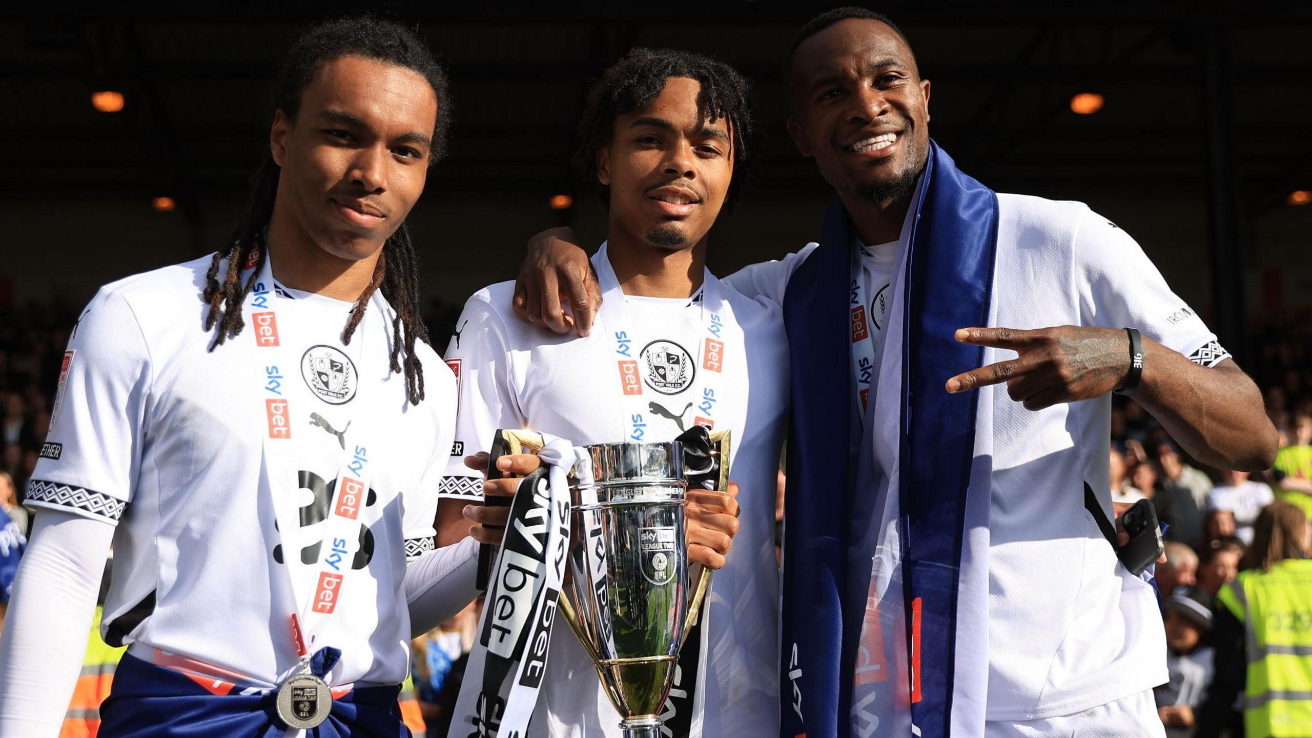 Rico Richards (left) holds the League Two runners-up trophy following the club's promotion to League One
