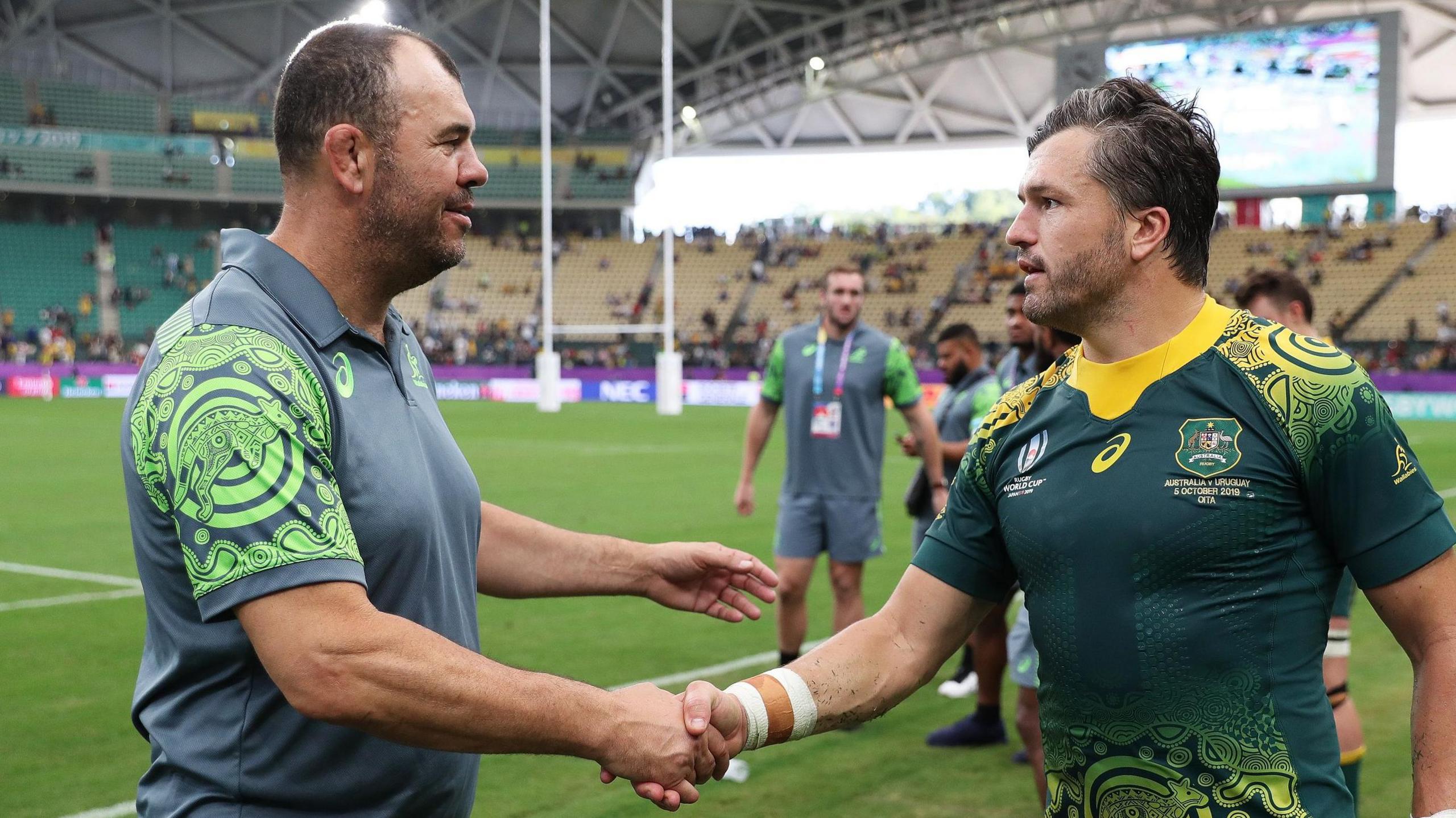 Then Australia head coach Michael Cheika (left) shakes hands with Adam Ashley-Cooper in 2019