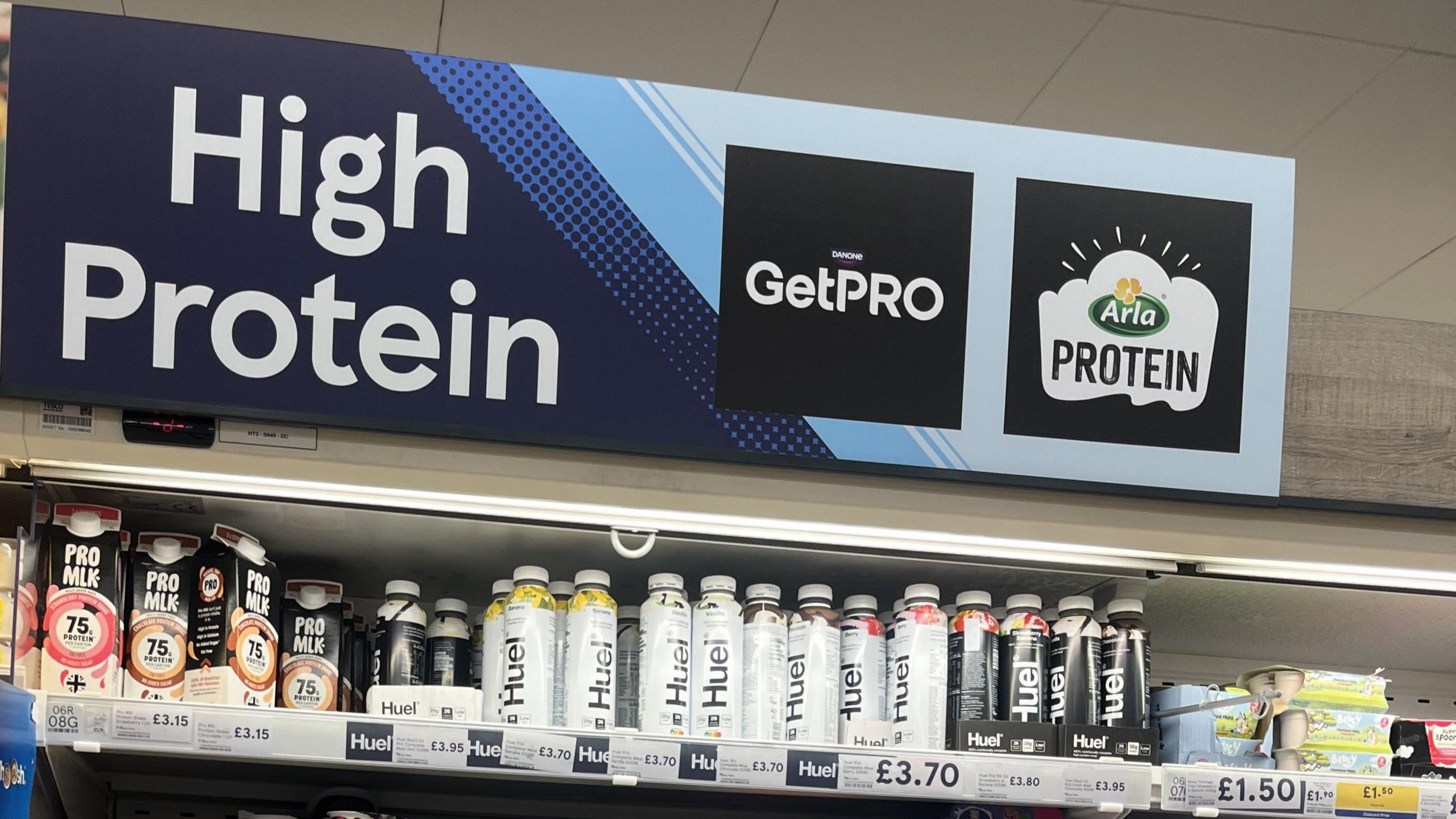 A supermarket shelf with high-protein products, including drinks and yoghurts.