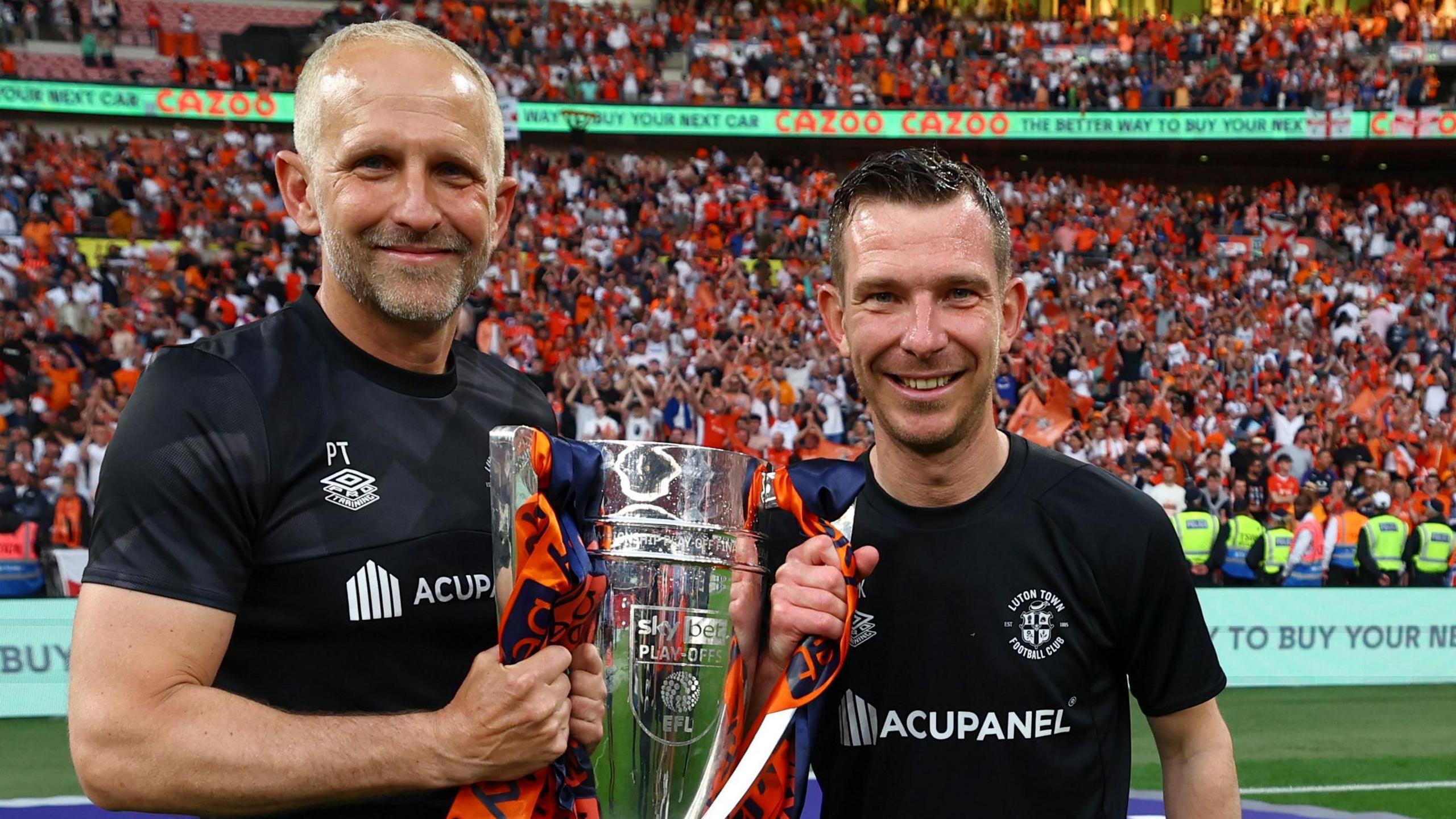 Paul Trollope and Richie Kyle hold the Championship play-off final trophy