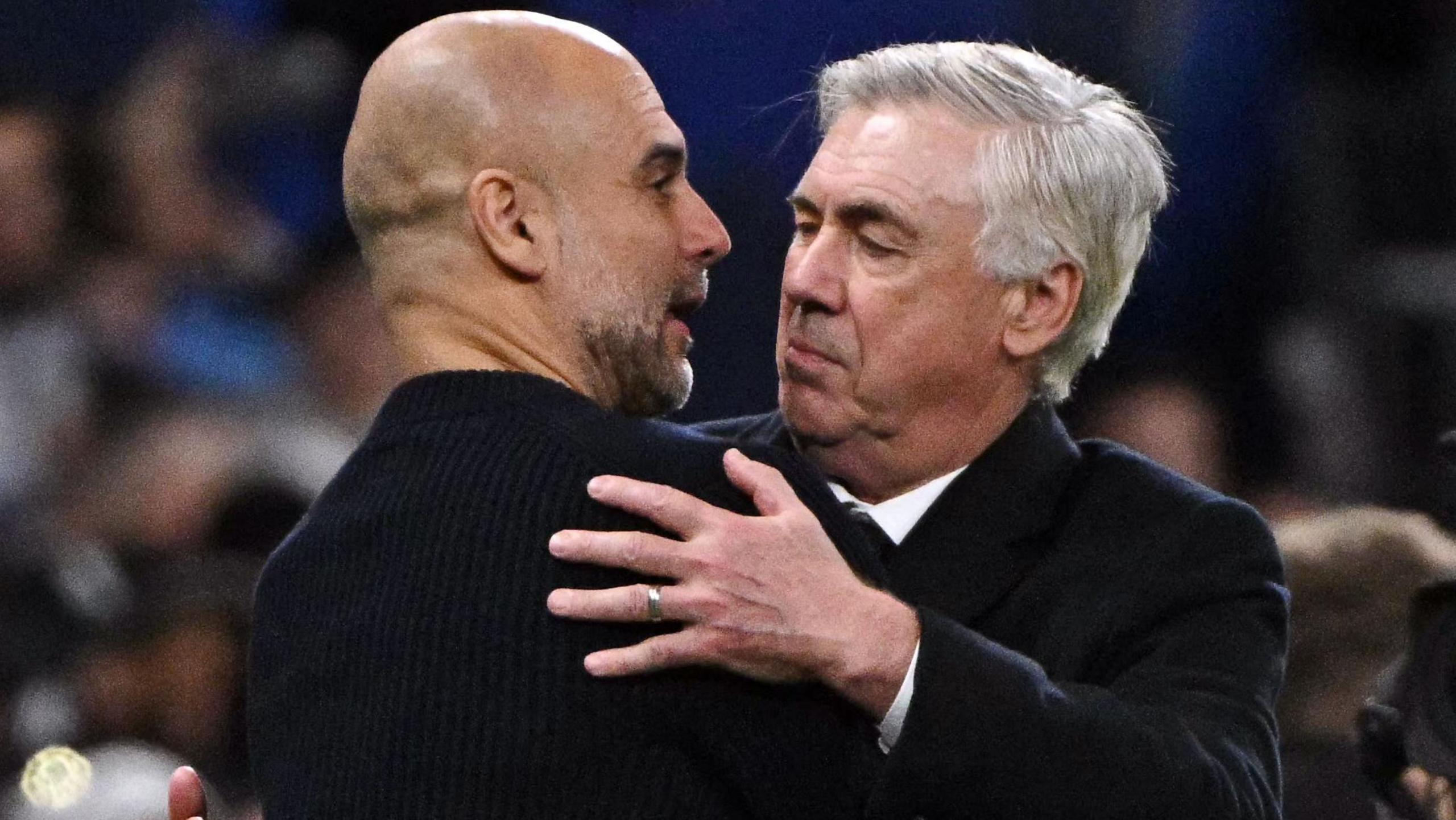 Manchester City's Spanish coach Pep Guardiola and Real Madrid's Italian coach Carlo Ancelotti hug each other