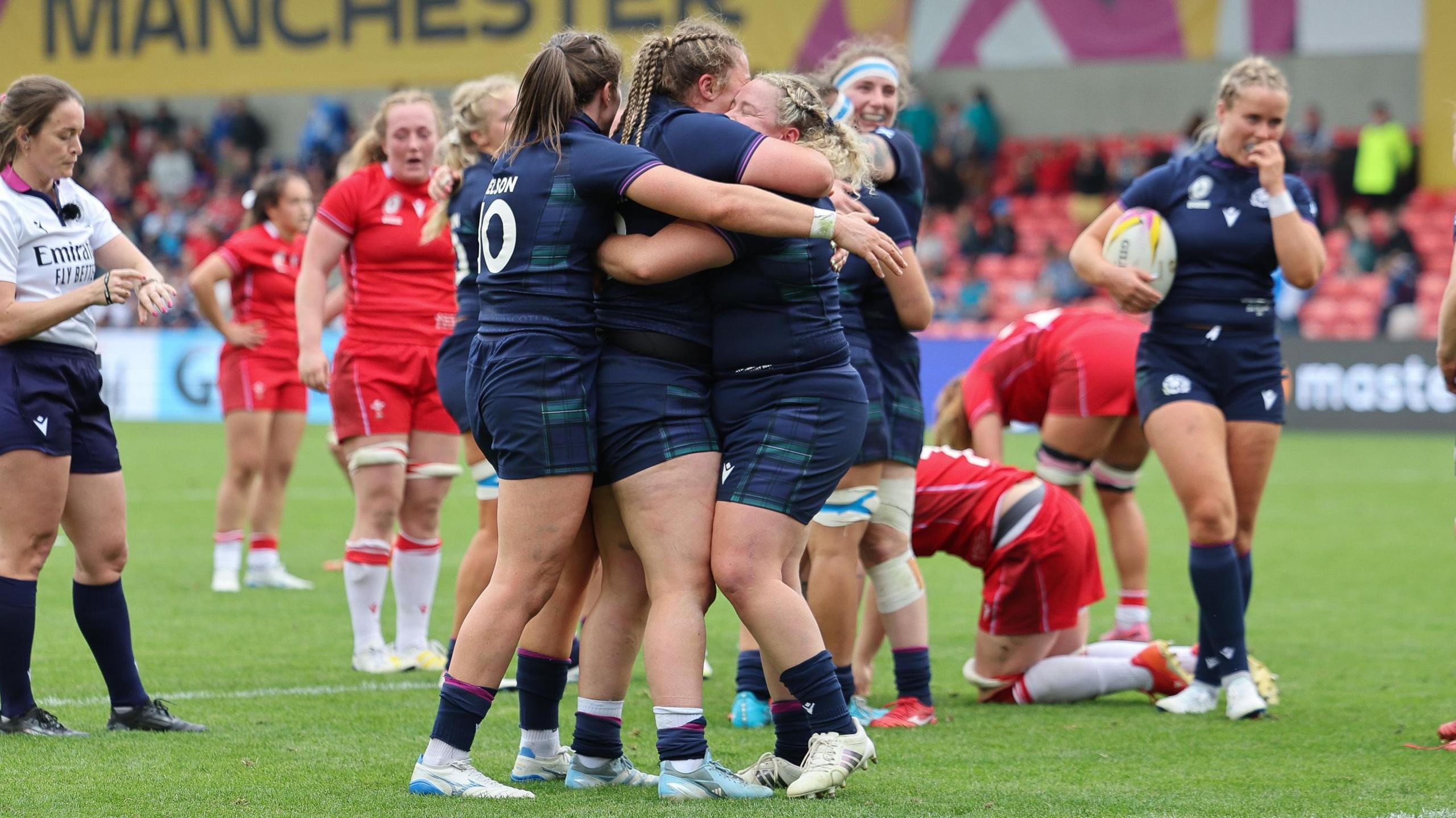Scotland players celebrate victory over a dejected Wales