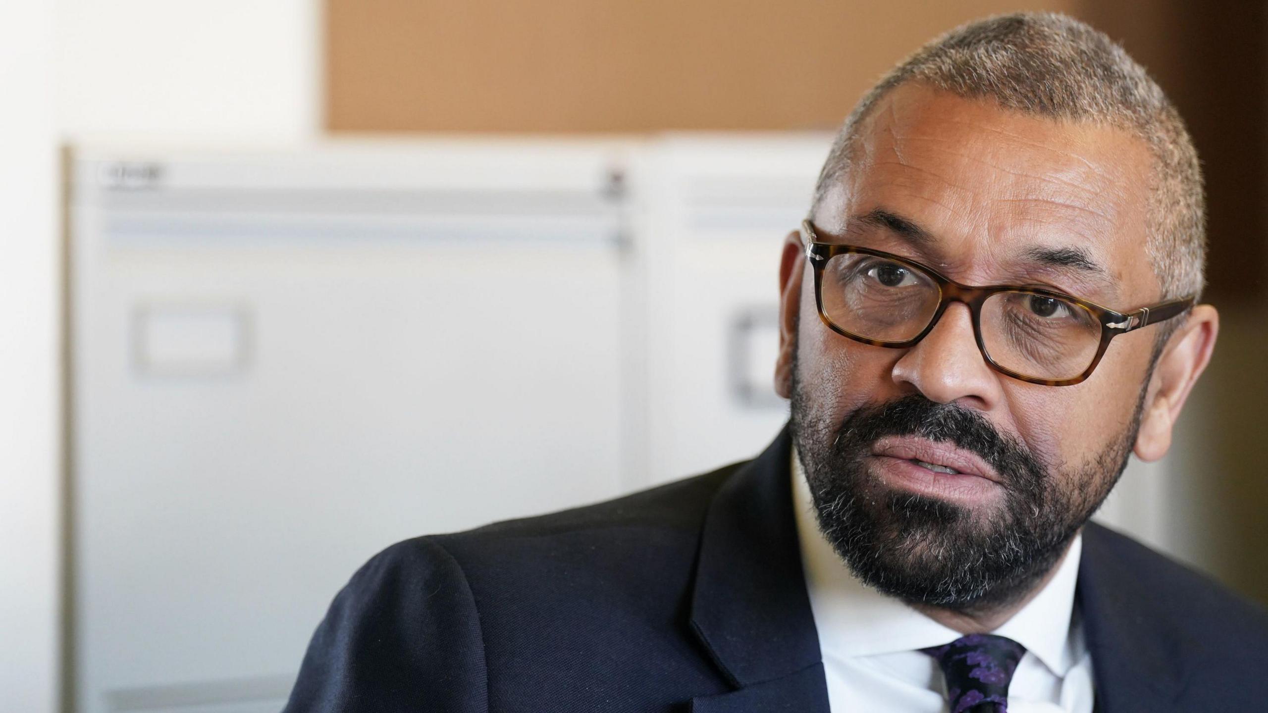 James Cleverly wearing a suit and tie