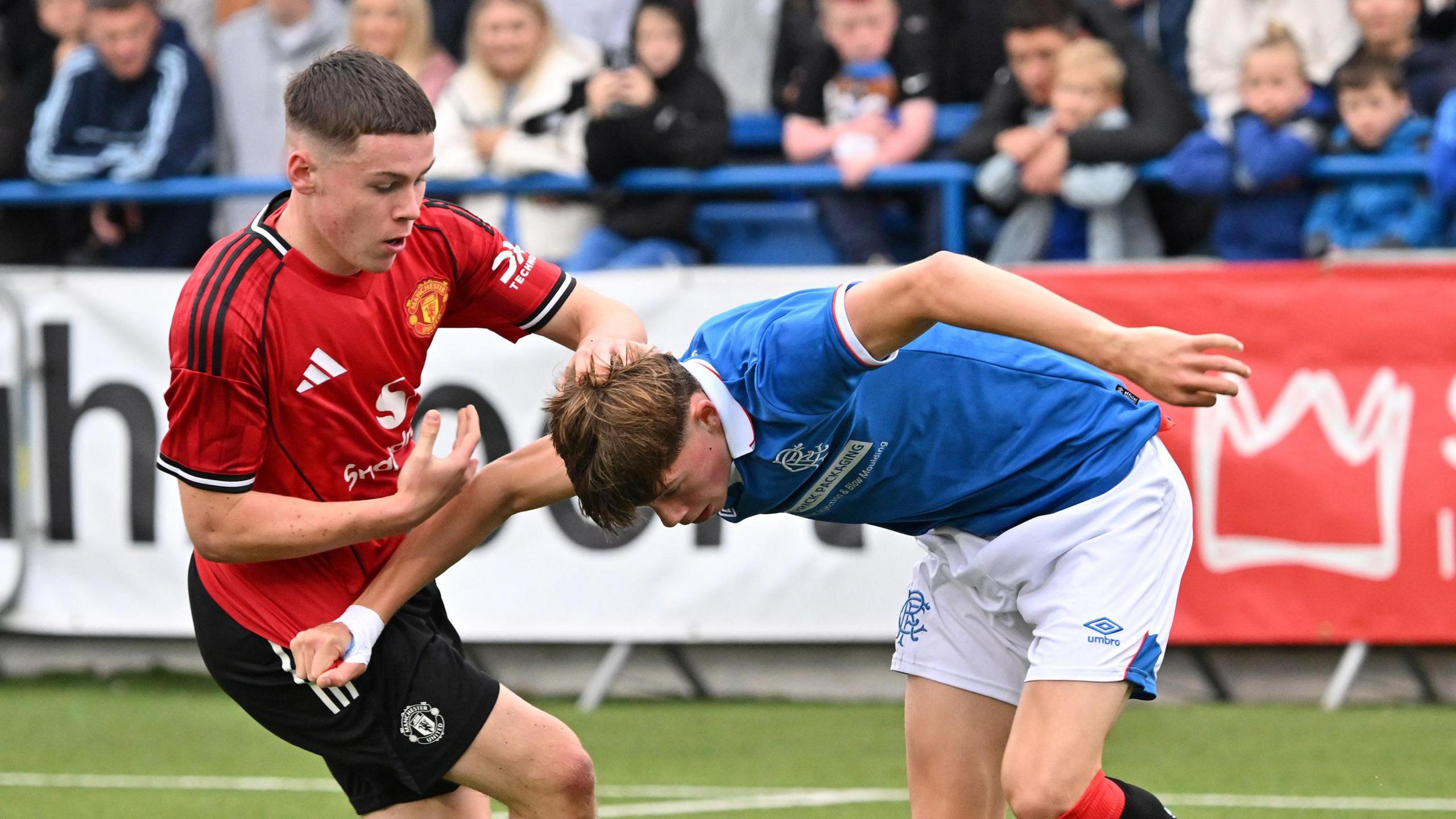 Kai Rooney makes a tackle against Rangers