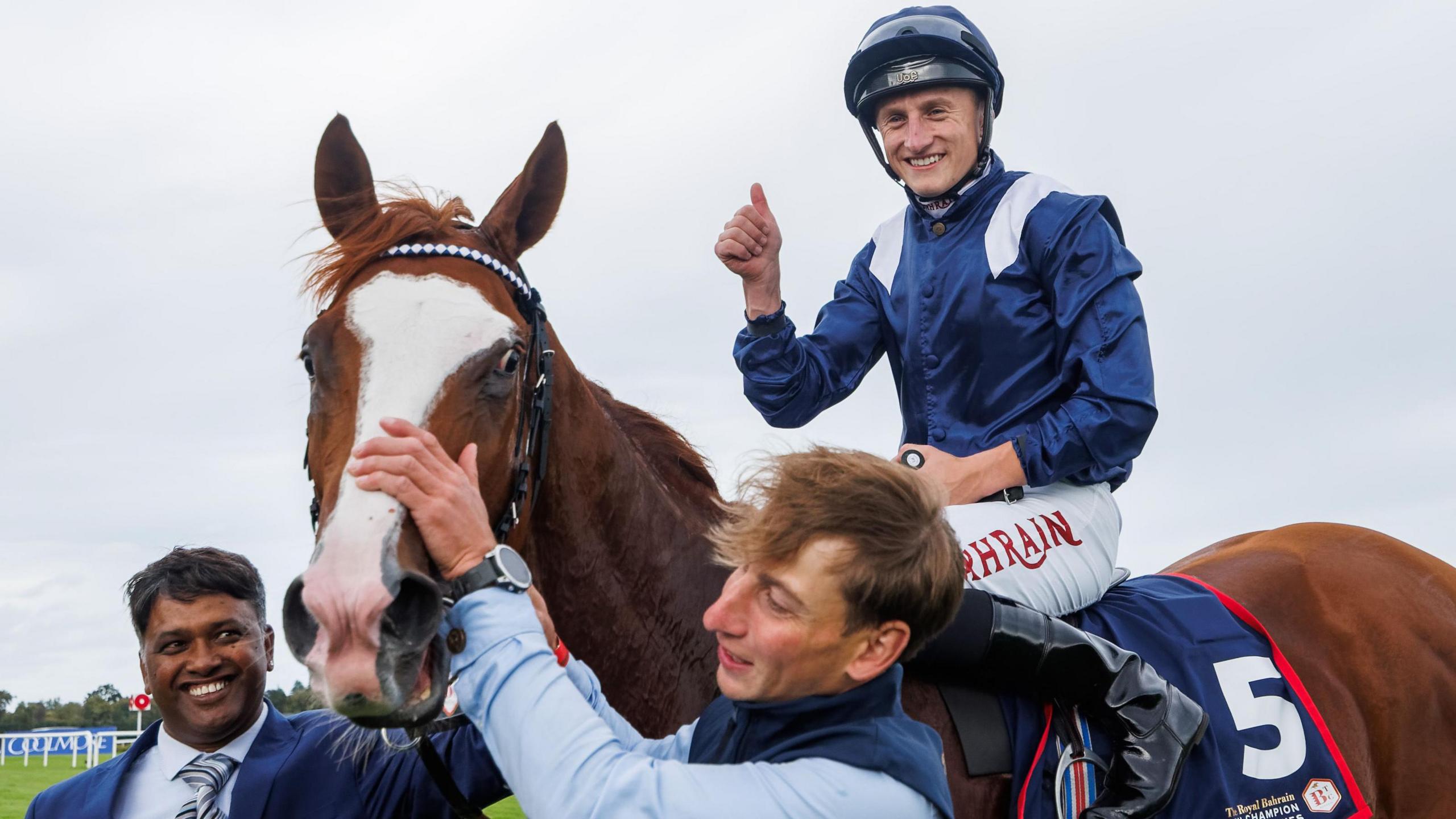 Tom Marquand celebrates after his Irish Champions Stakes on Economics at Leopardstown