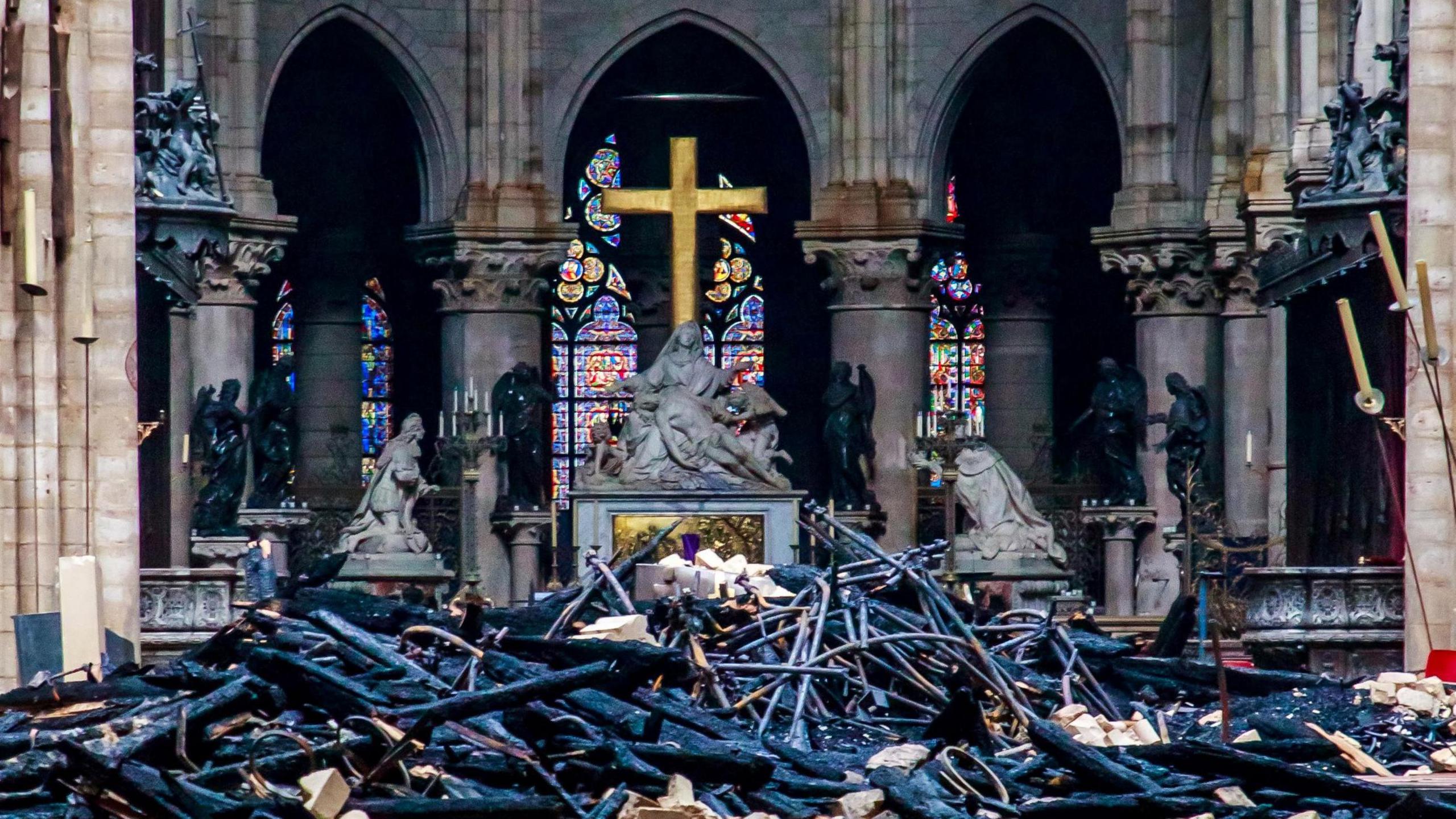 Notre-Dame Cathedral fire: A view of the heart and transept and the cross and sculpture of Pieta by Nicolas Coustou