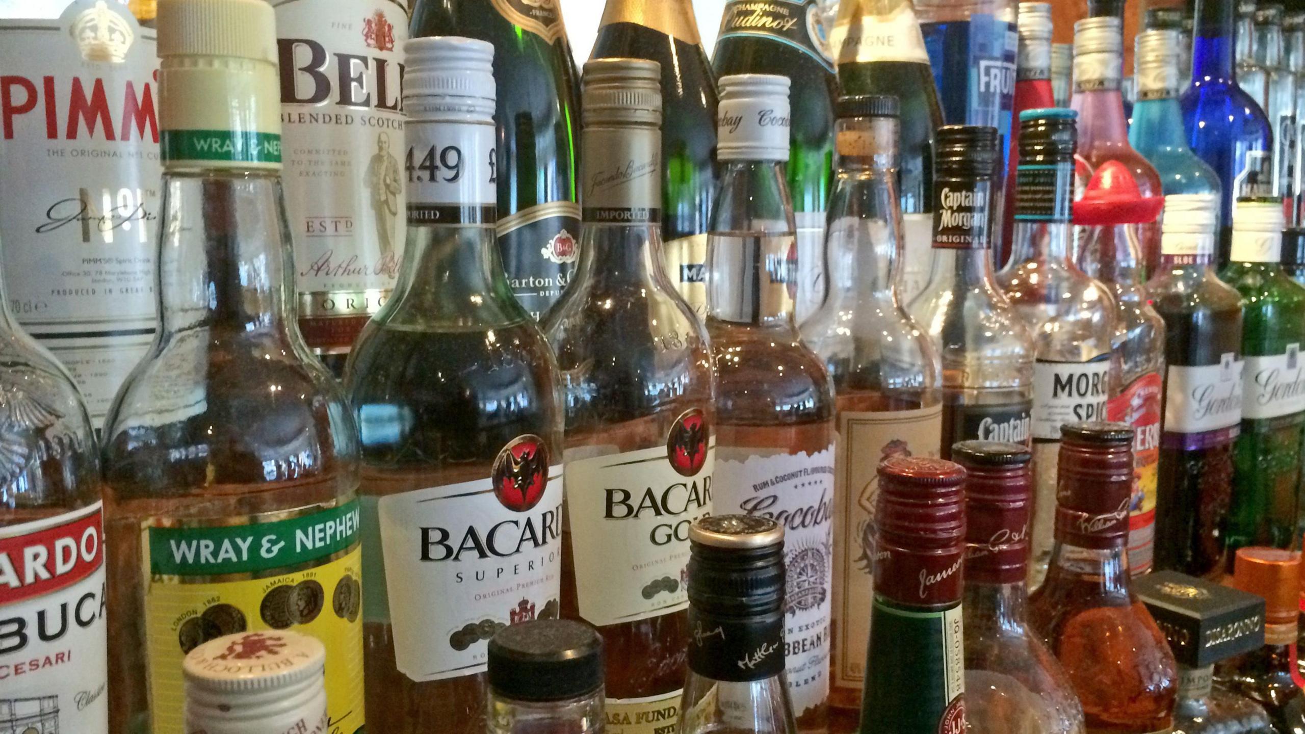 Bottles of spirits in three rows. There are brands such as Pimm's, Barcard and Gordons. 