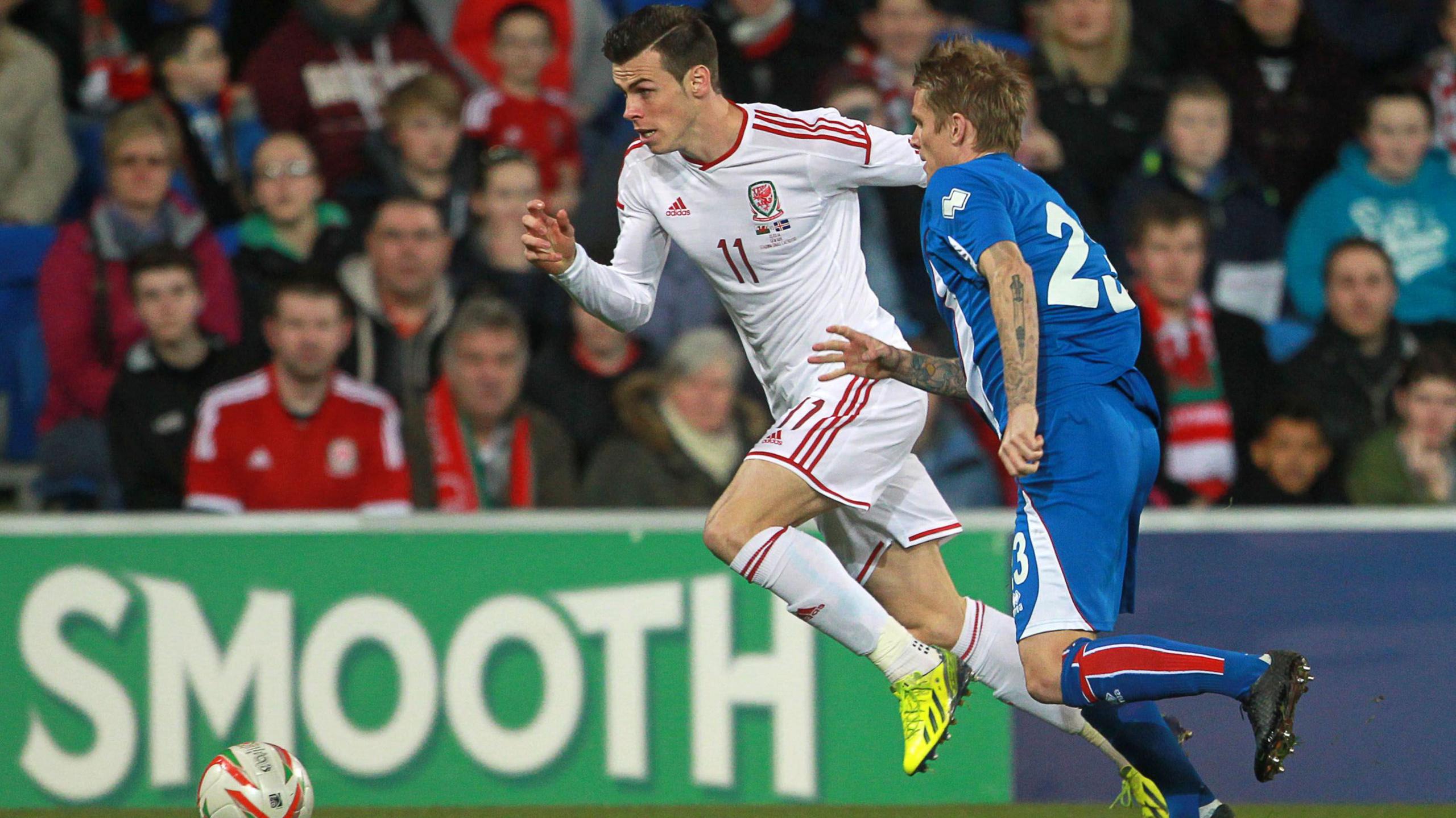 Gareth Bale of Wales (left) gets past Ari Freyr Skulason of Iceland 