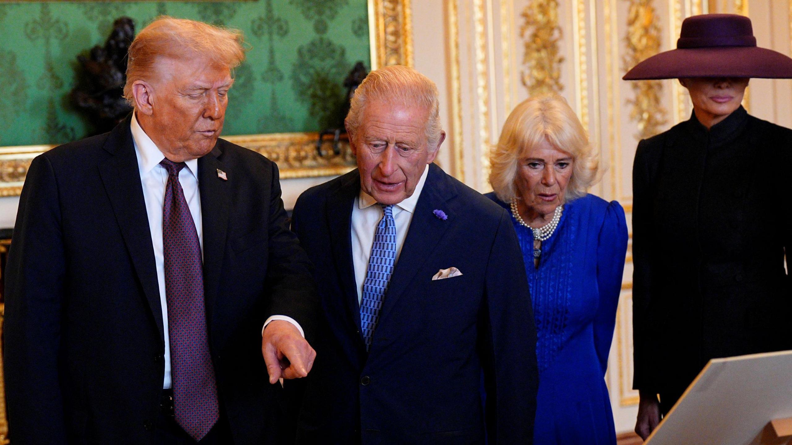 (left-right) US President Donald Trump, King Charles III, Queen Camilla and First Lady Melania Trump viewing items on display at the Royal Collection exhibition
