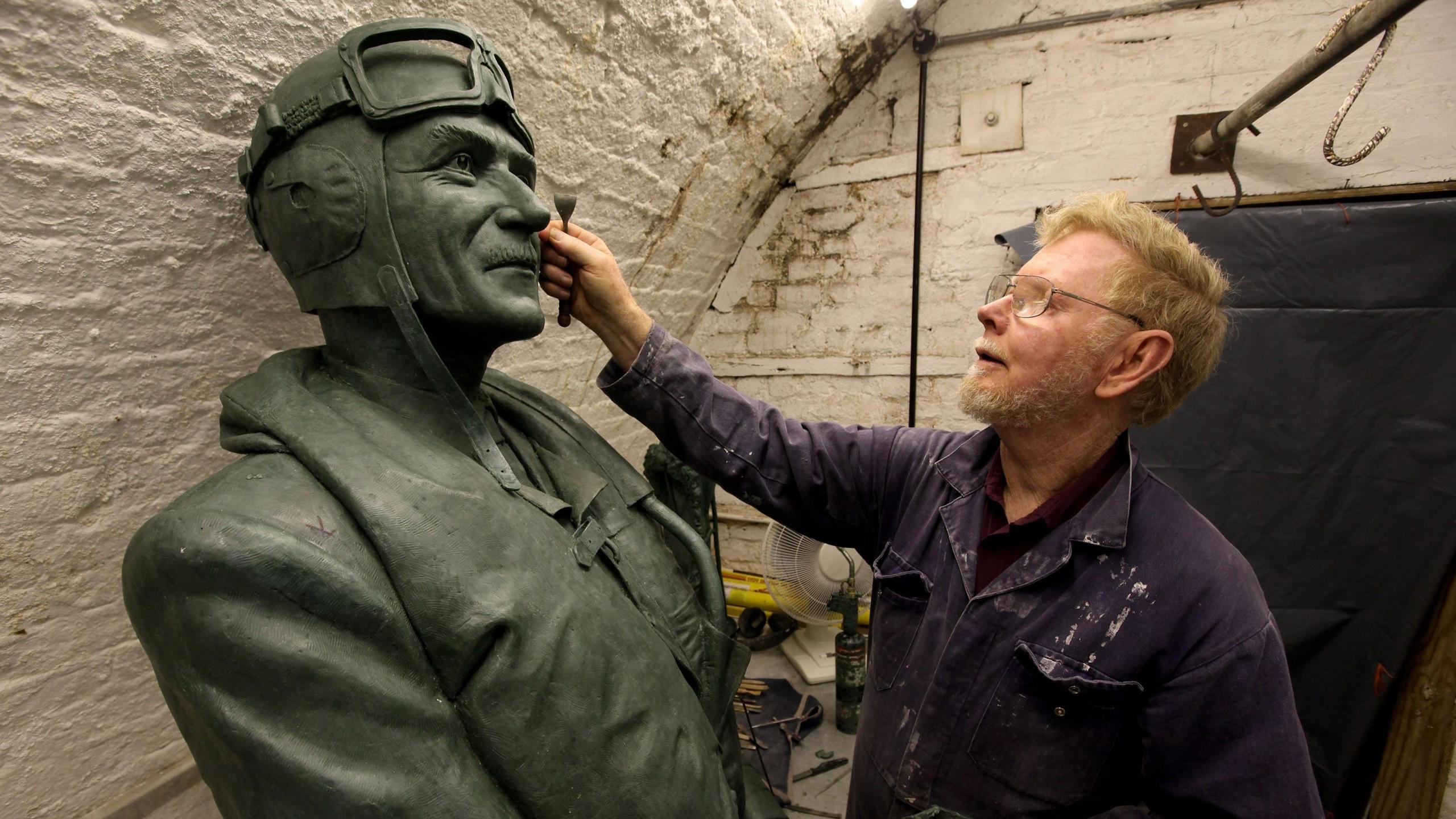 Les Johnson, the sculptor of a 9 foot high bronze statue of Sir Keith Park, stands next to a wax sculpture used in the casting process in the 'Bronze Age Sculpture Foundry' on July 9, 2010 in London, England.
