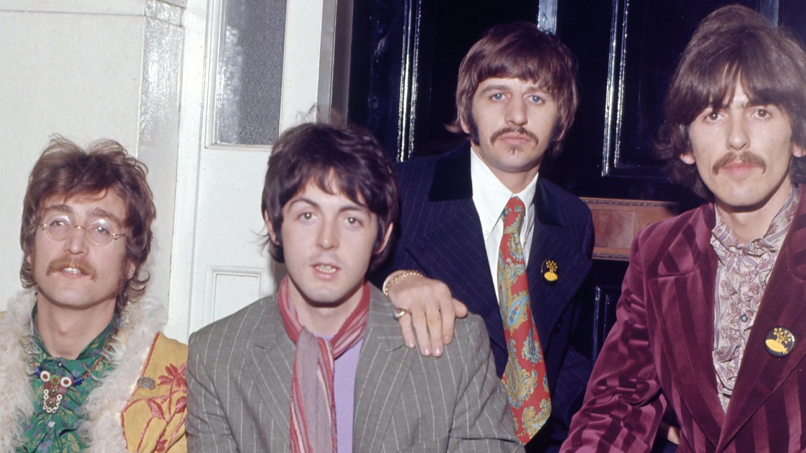 (Left to right) A colourfully dressed John Lennon, Paul McCartney, Ringo Starr and George Harrison sat outside the London home of manager Brian Epstein in support of the release of Sgt. Pepper's Lonely Hearts Club Band in May 1967