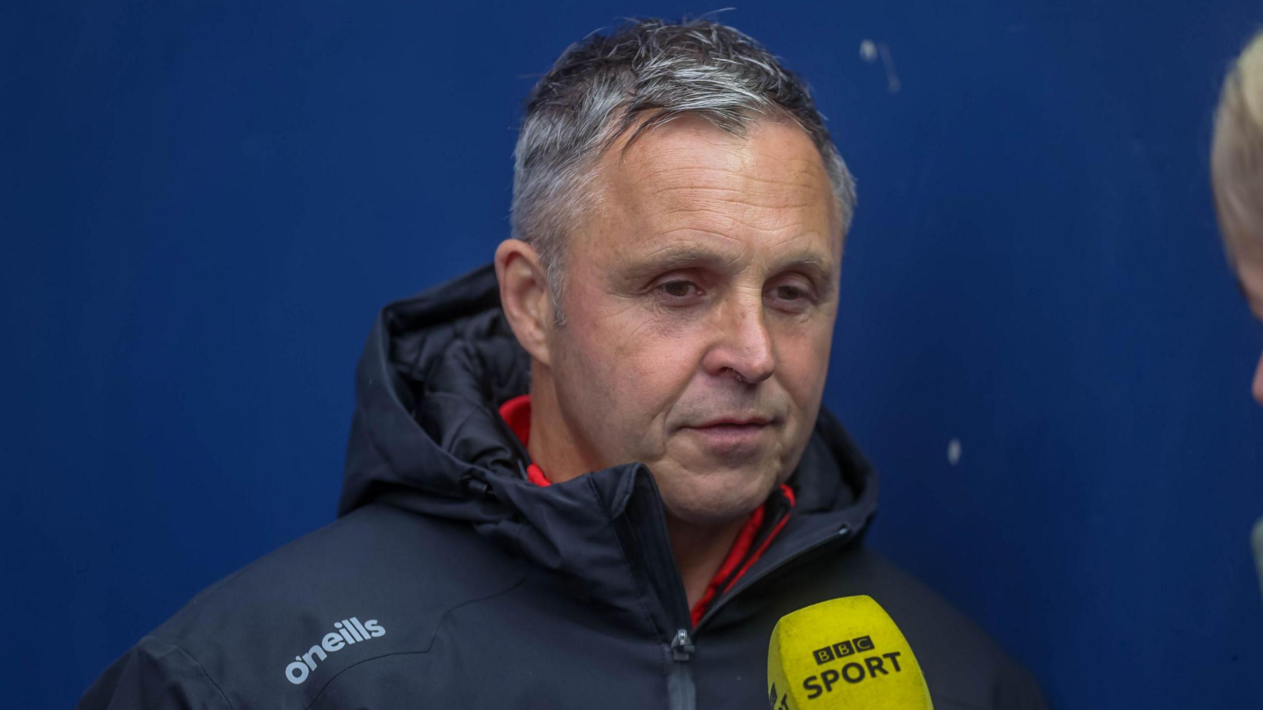 Paul Rowley speaking into a BBC Sport microphone