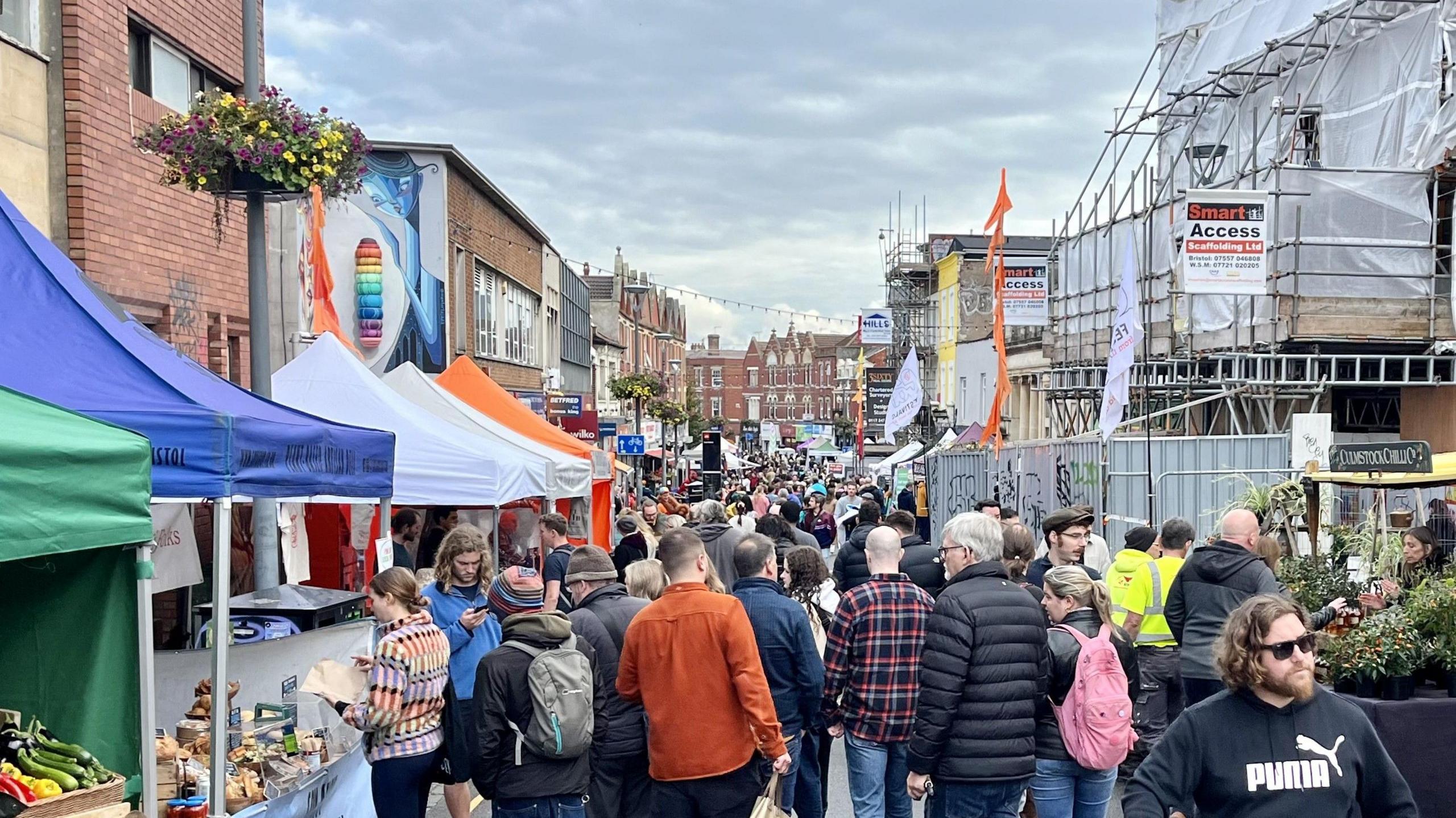 Crowds of people are seen walking down East Street in Bedminster looking at different food stalls as part of the eat Bedminster food fair