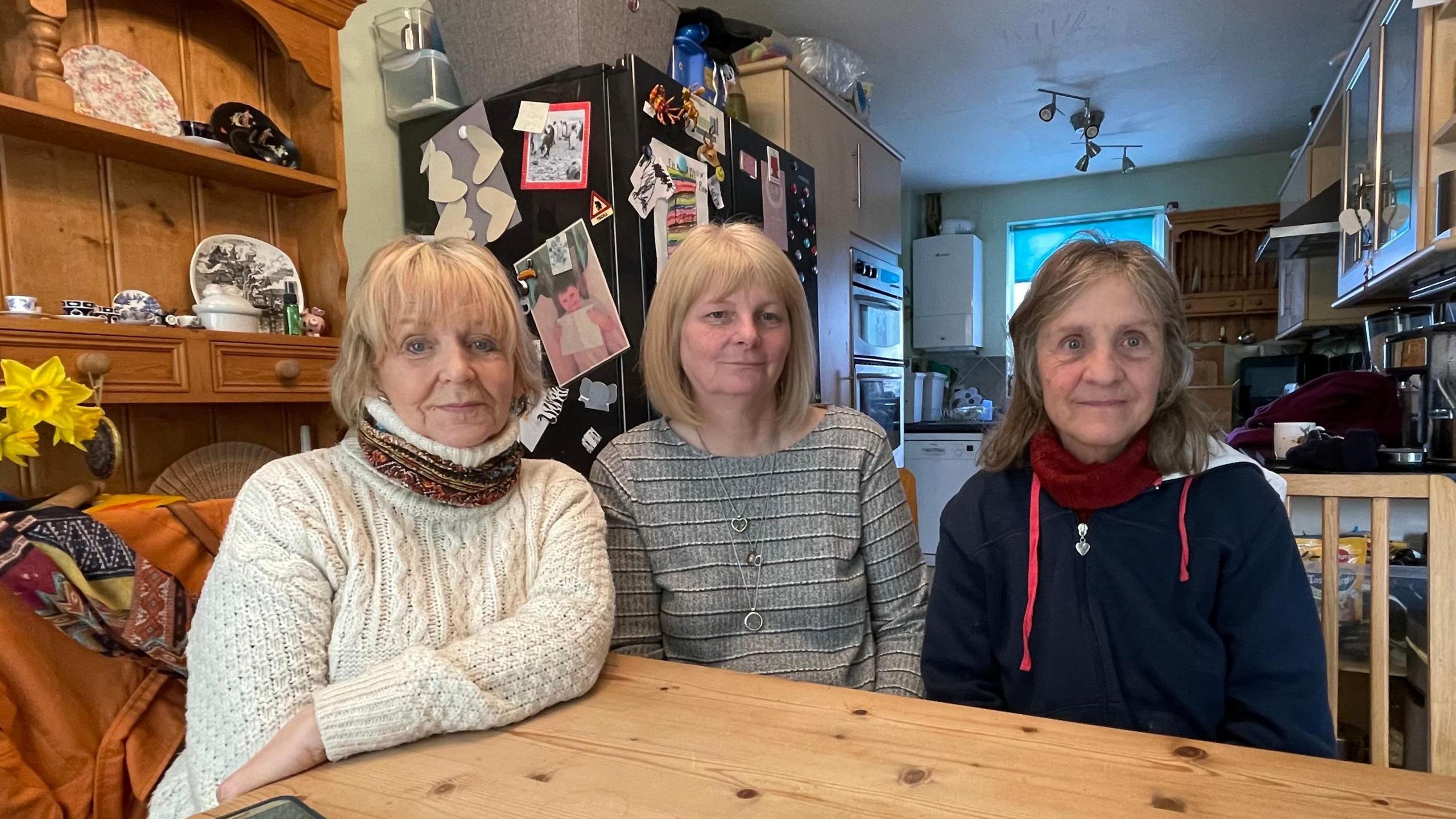 Mandy Richardson, Rachael Green and Sue Townsend sit at a kitchen table.