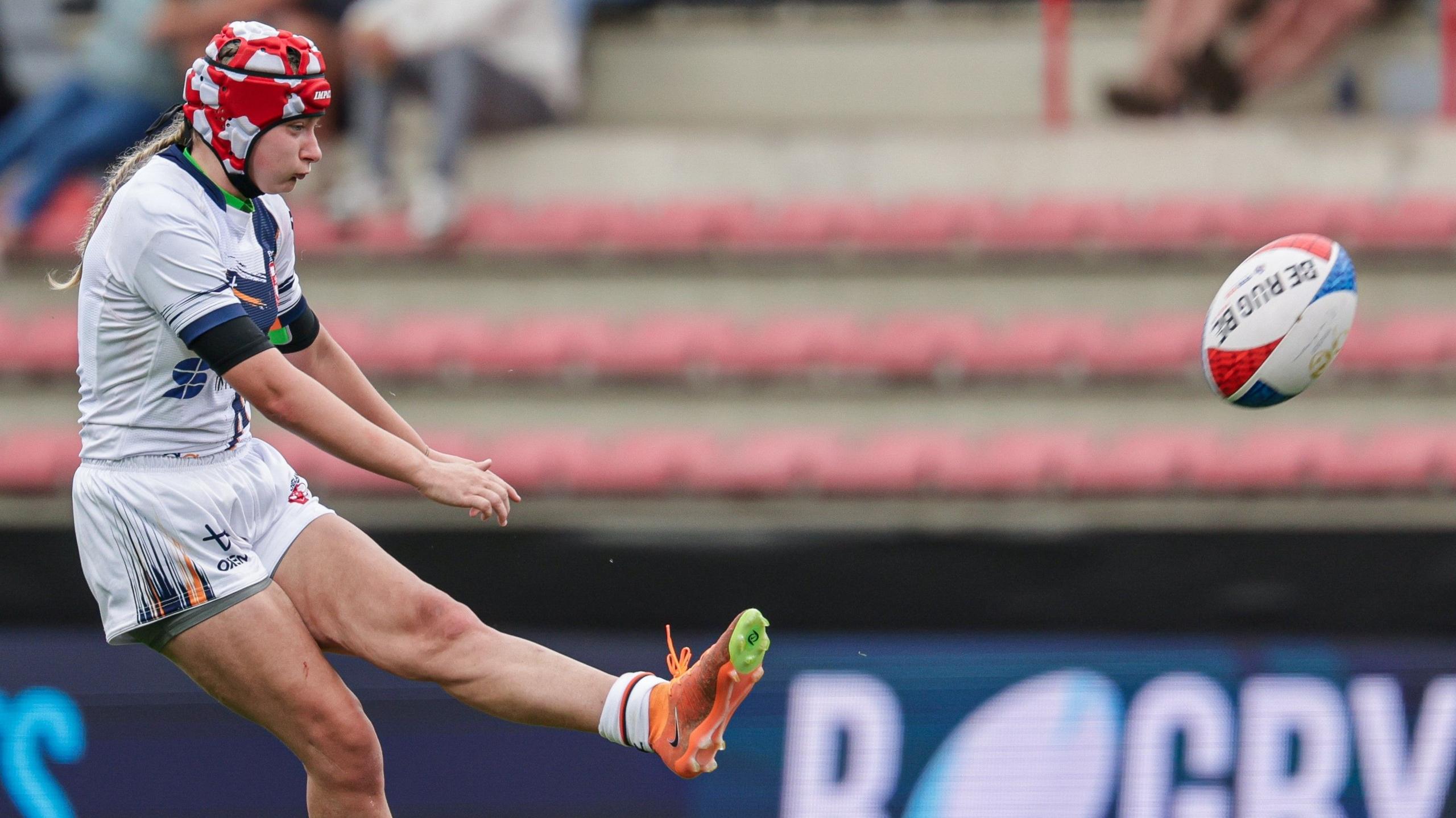 Isabel Rowe kicks a conversion for England