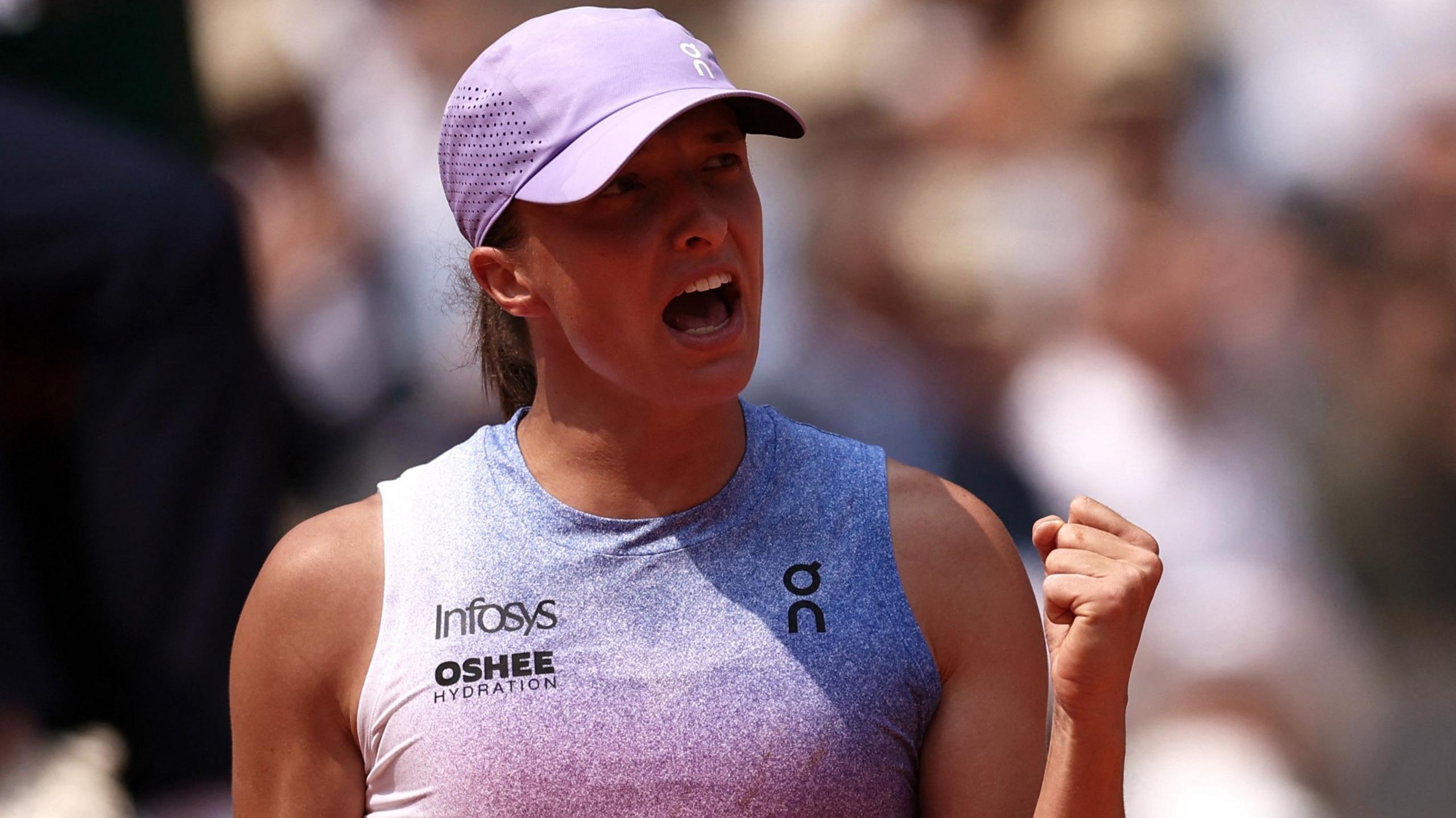 Iga Swiatek clenches her fist after victory over Elina Svitolina at the French Open