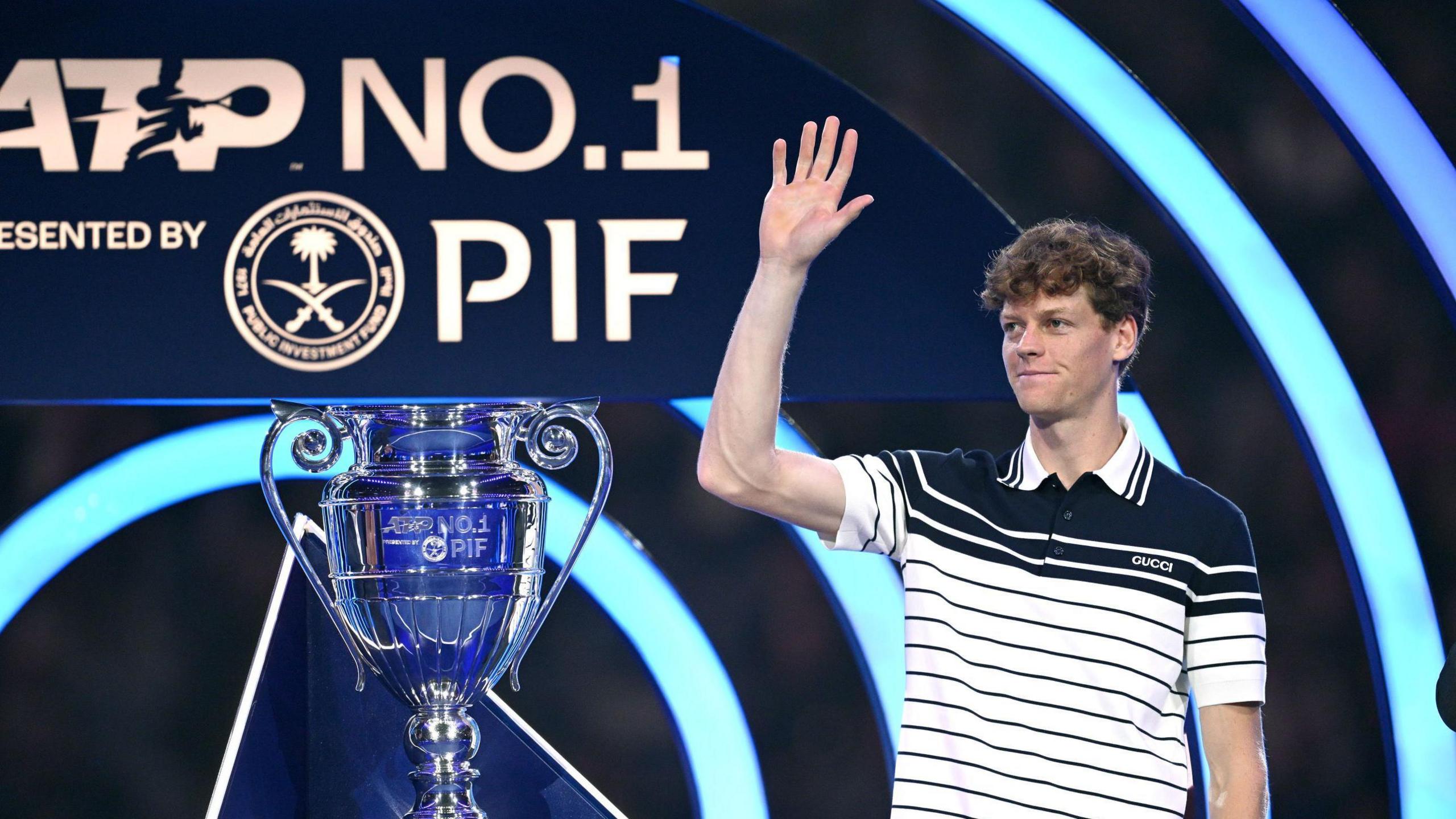 Jannik Sinner receives the ATP trophy for finishing year-end number one