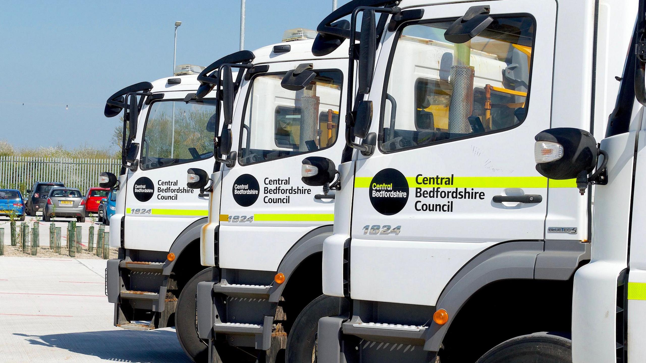 Three parked gritting lorries on a sunny day with Central Bedfordshire branding on the doors.