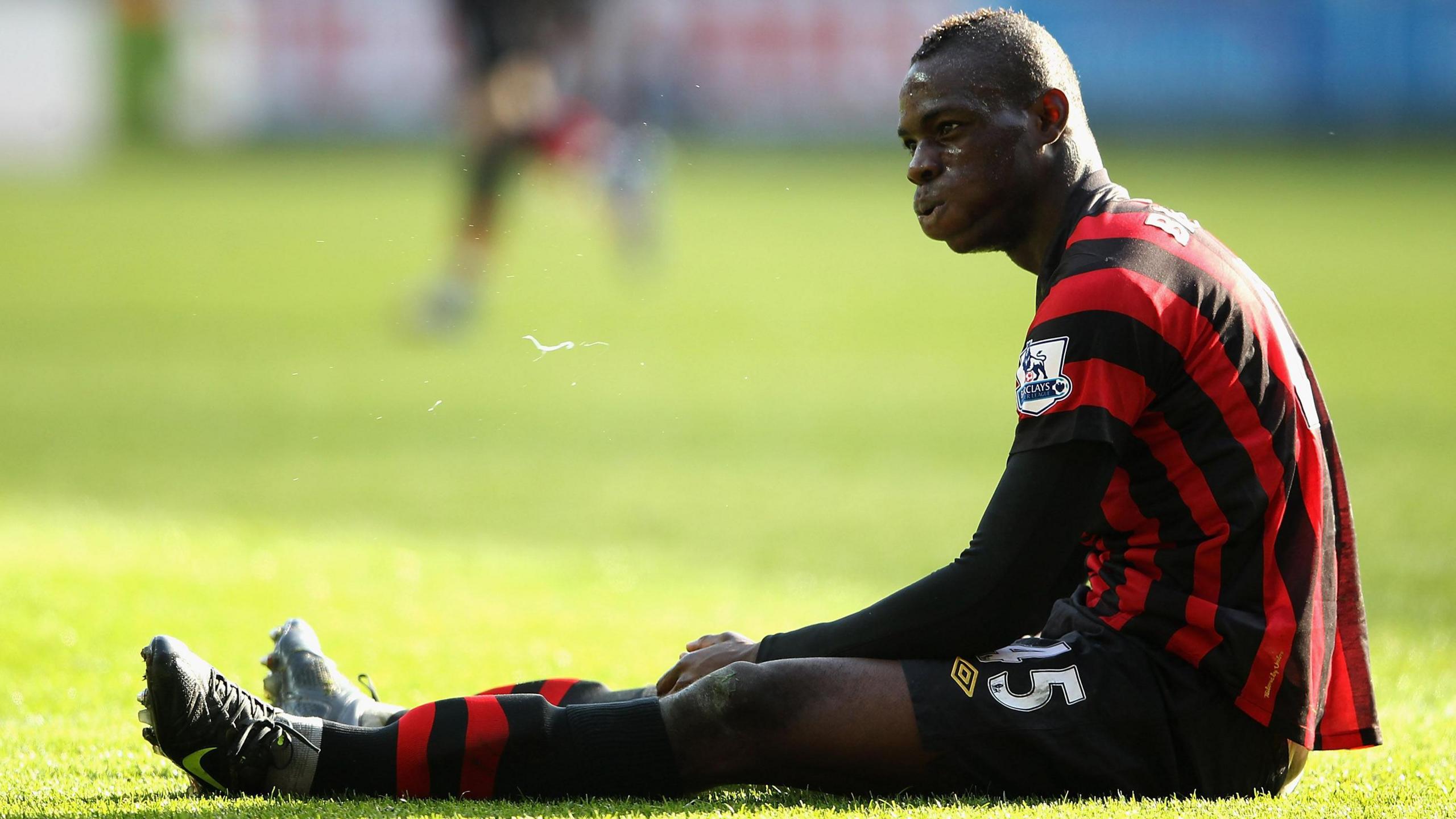 Mario Balotelli sits on the turf during Manchester City's loss at Swansea in 2012