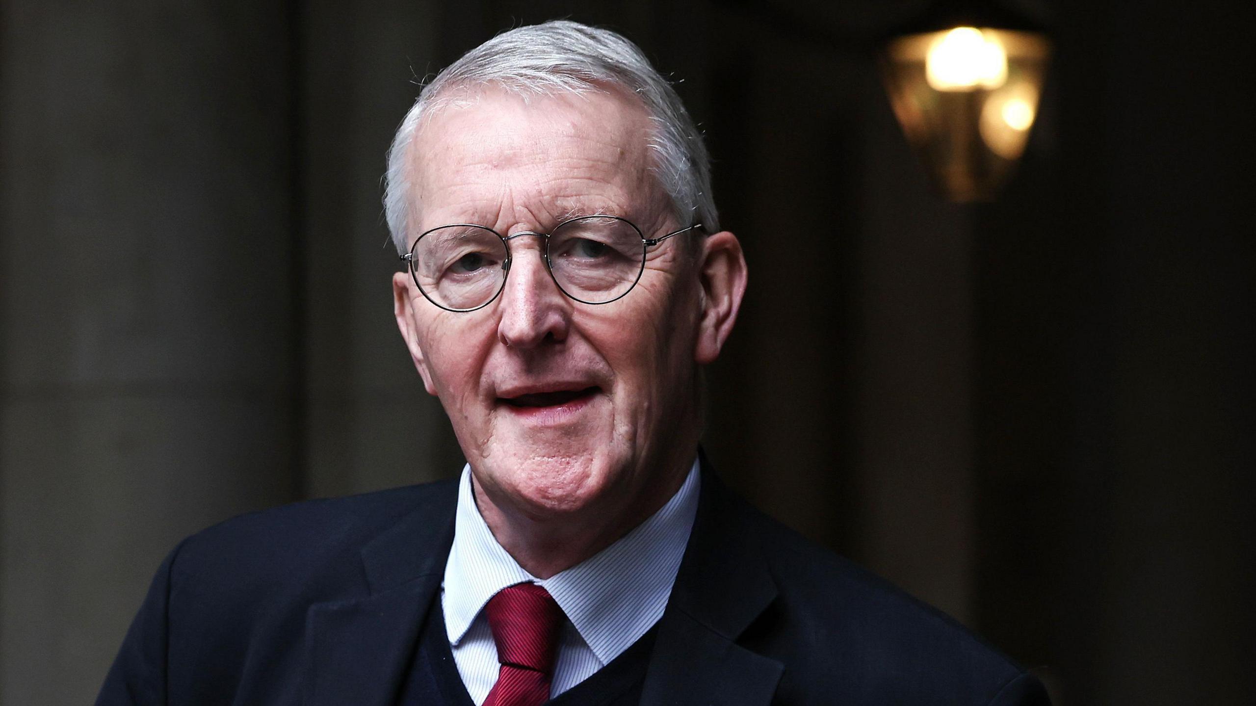 Headshot of Hilary Benn wearing a suit and tie