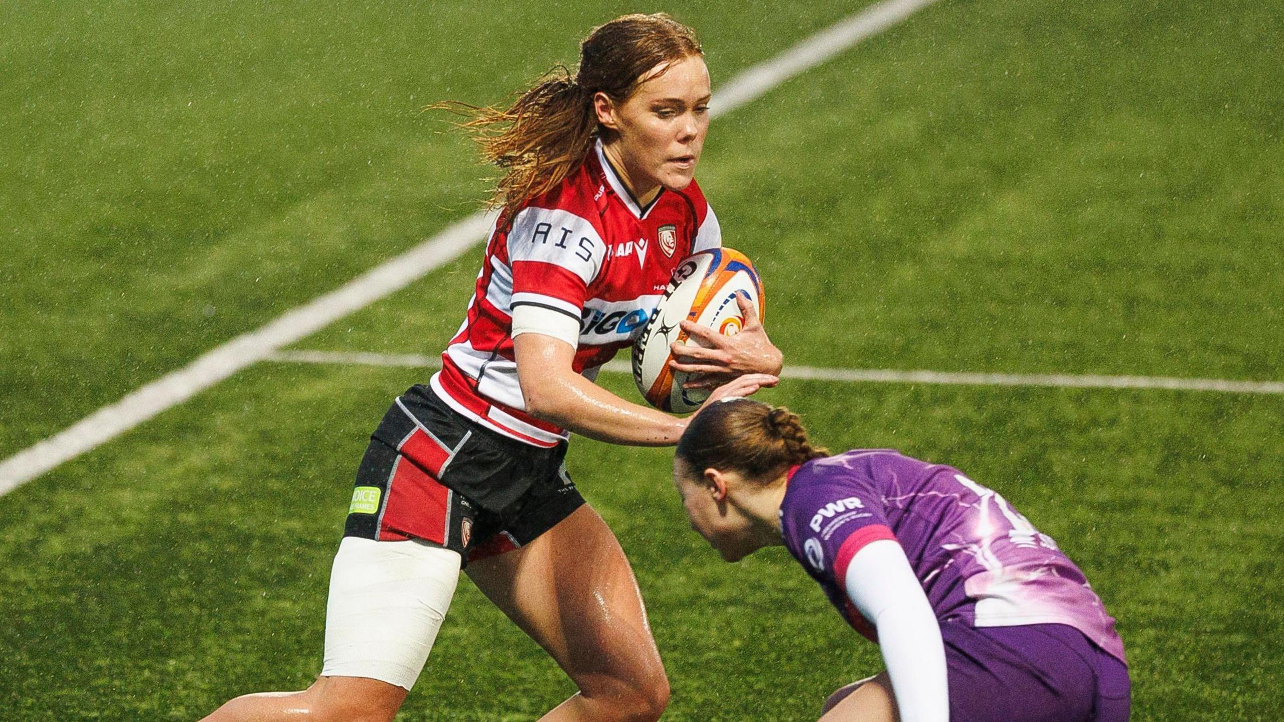 Gloucester Hartpury's Mia Venner avoids a tackle from a Loughborough player during their match