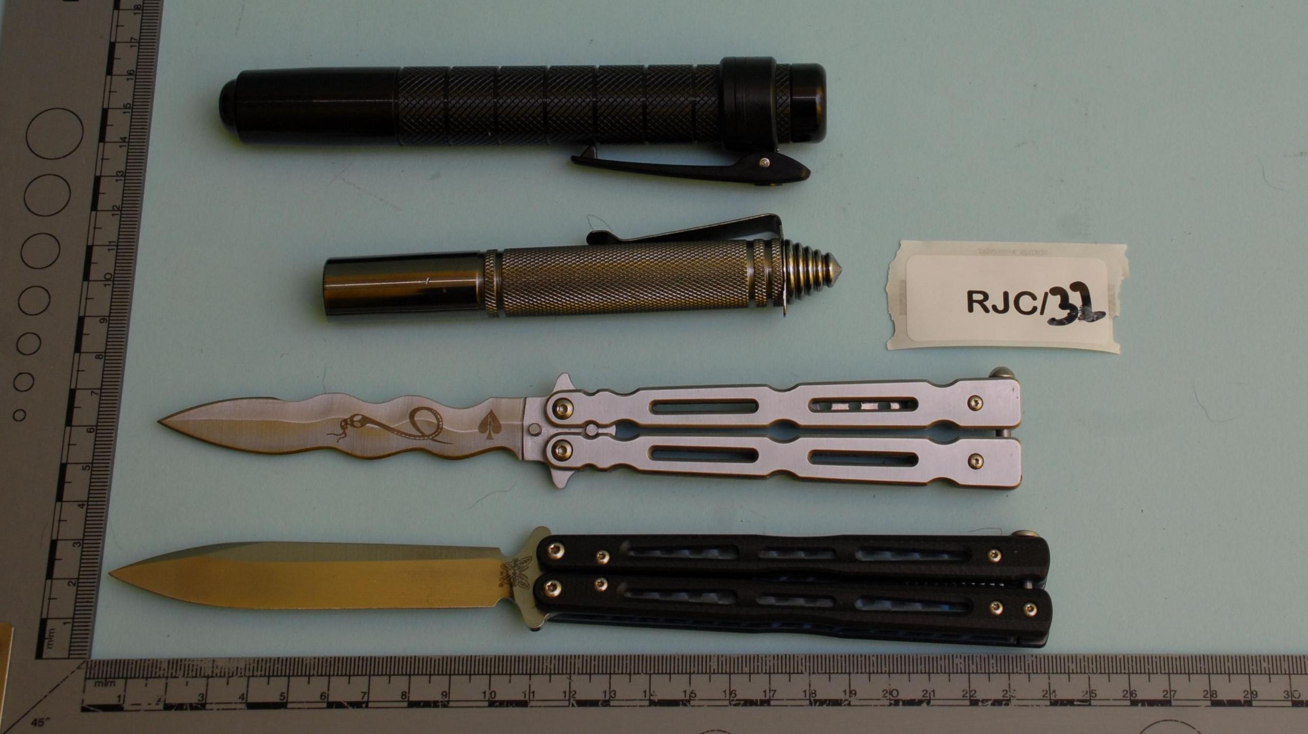 Two batons and laid out next to two knives
