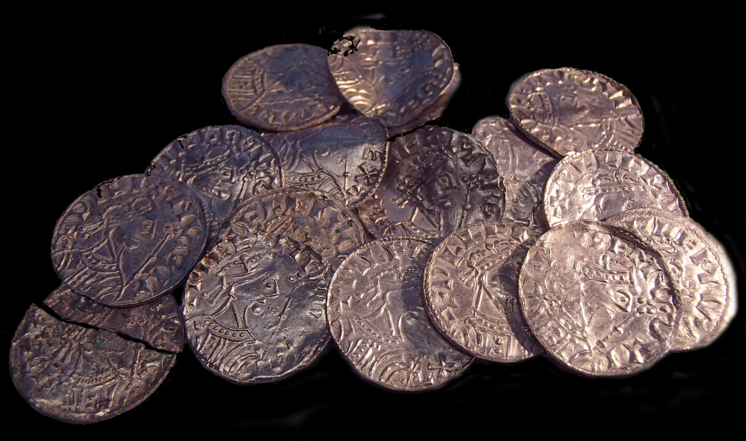 Sixteen Norman coins lying in a pile, they are known as the Chew Valley Hoard
