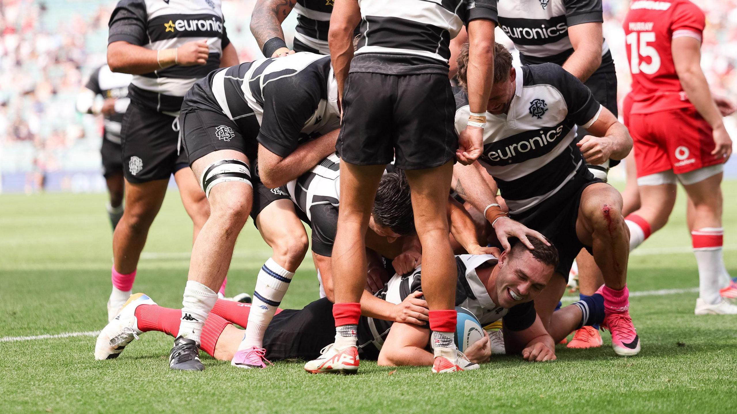 George North is congratulated by Barbarians teammates