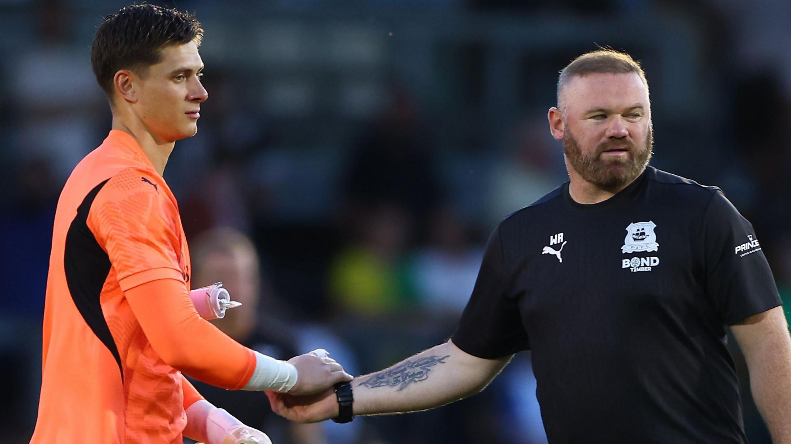 Michael Cooper shakes Wayne Rooney's hand