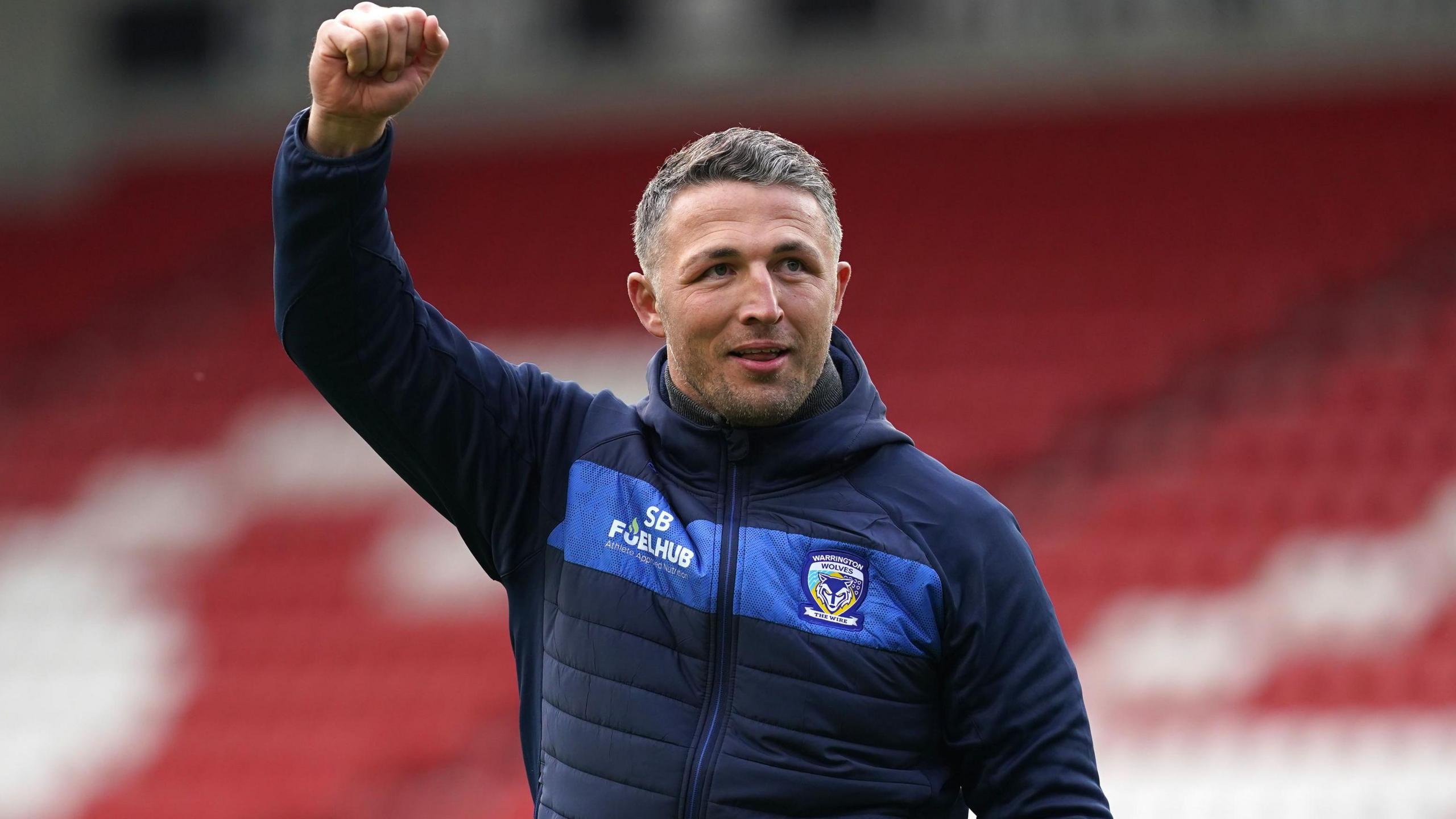 Warrington boss Sam Burgess raises a fist in celebration