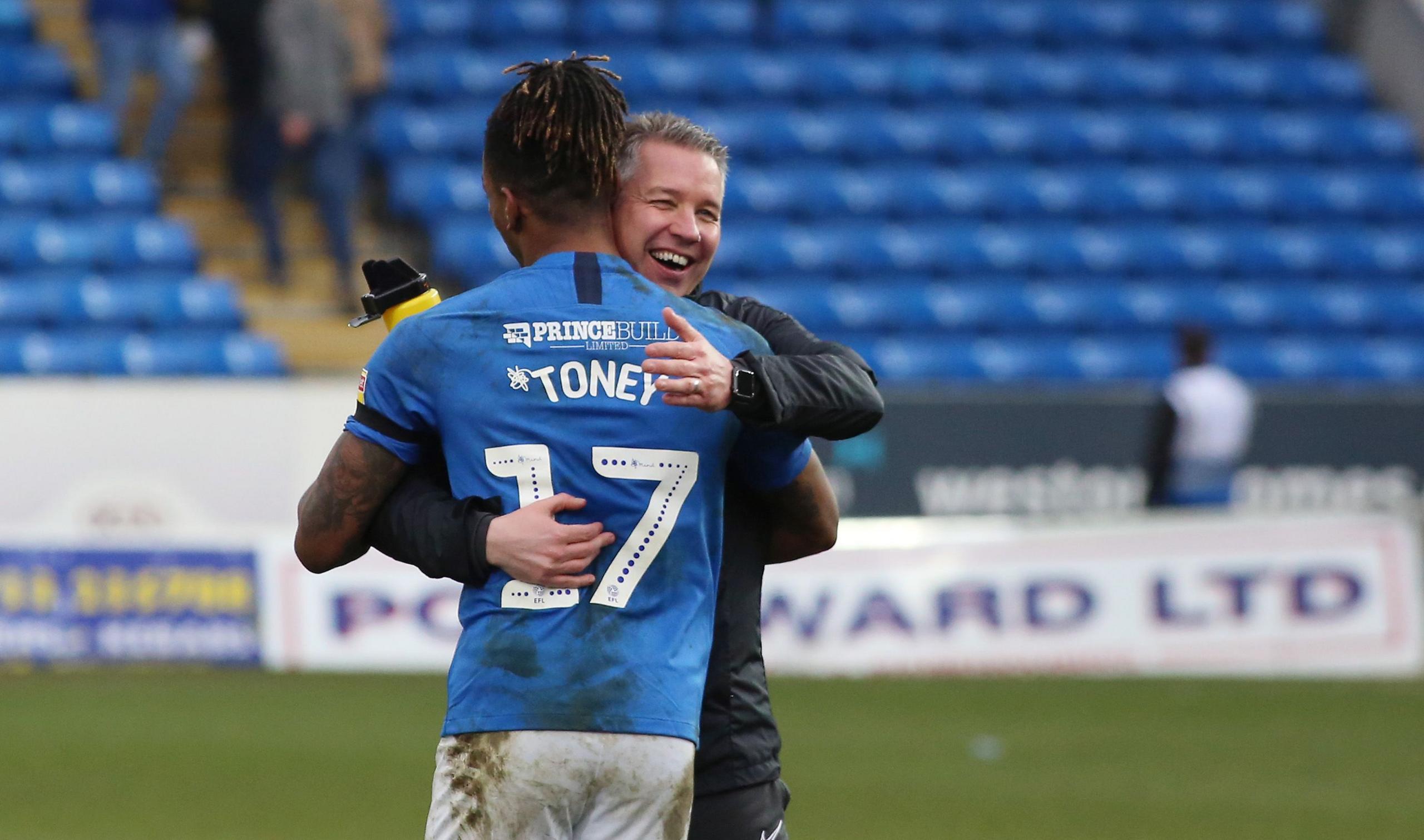 Ivan Toney and Darren Ferguson hug each other following a win over Portsmouth in March 2020