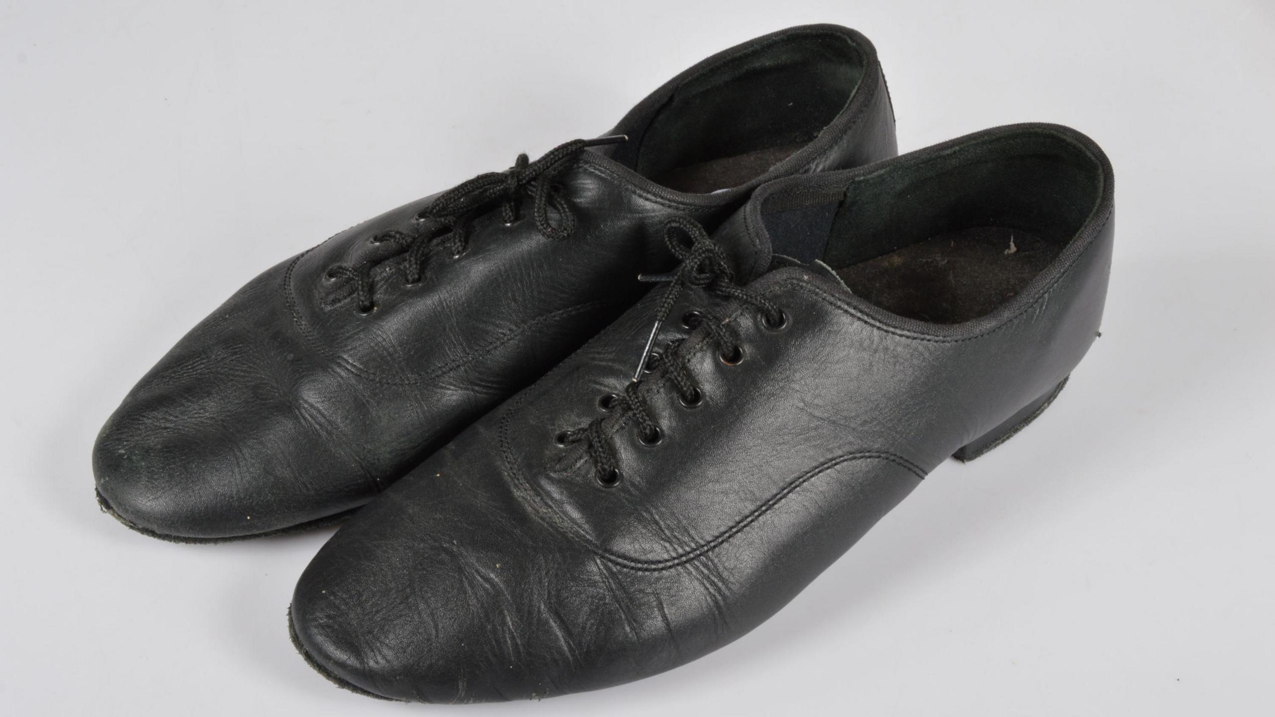 A pair of black leather shoes. 