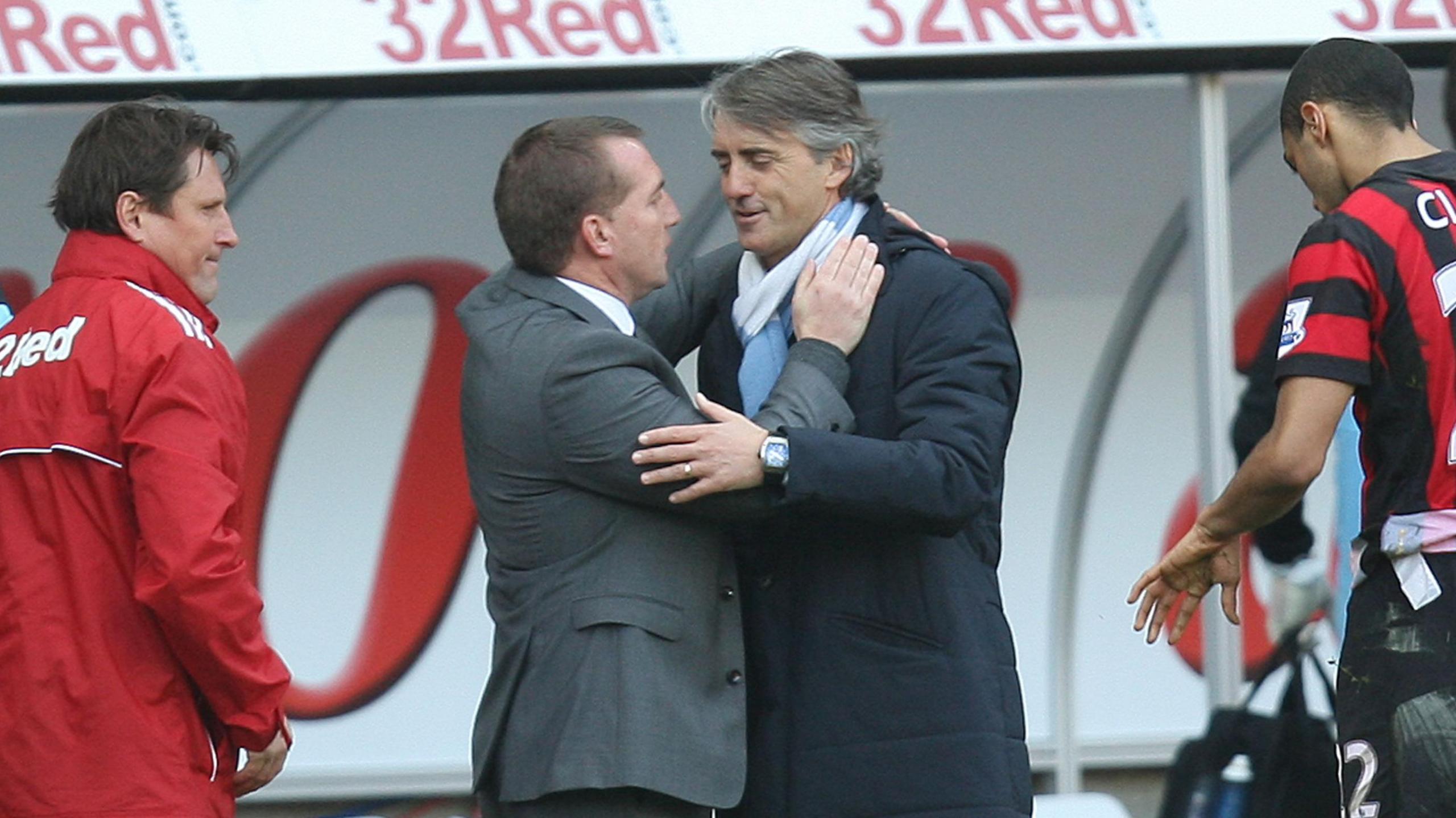 Brendan Rodgers embraces Roberto Mancini after Swansea's win over Manchester City