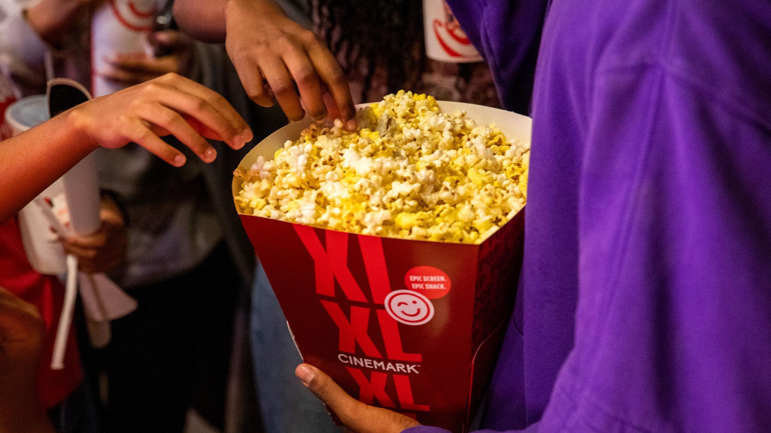 Guests eat popcorn at the Cinemark Baldwin Hills Crenshaw and XD movie theatre in Los Angeles, California, US, on Monday, July 22, 2024.