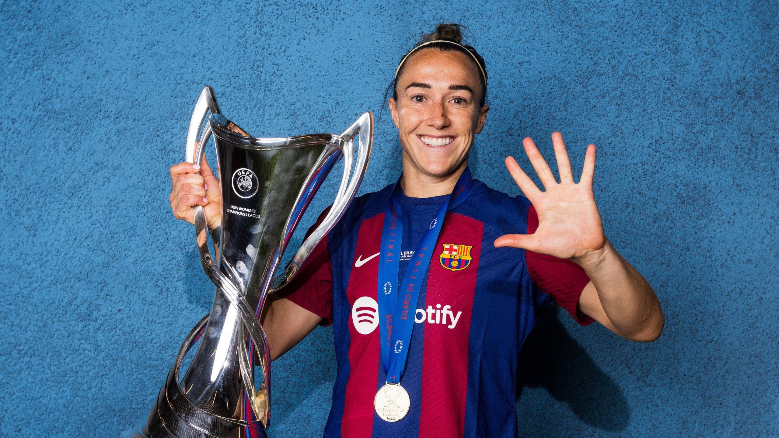 Lucy Bronze holds the Champions League trophy