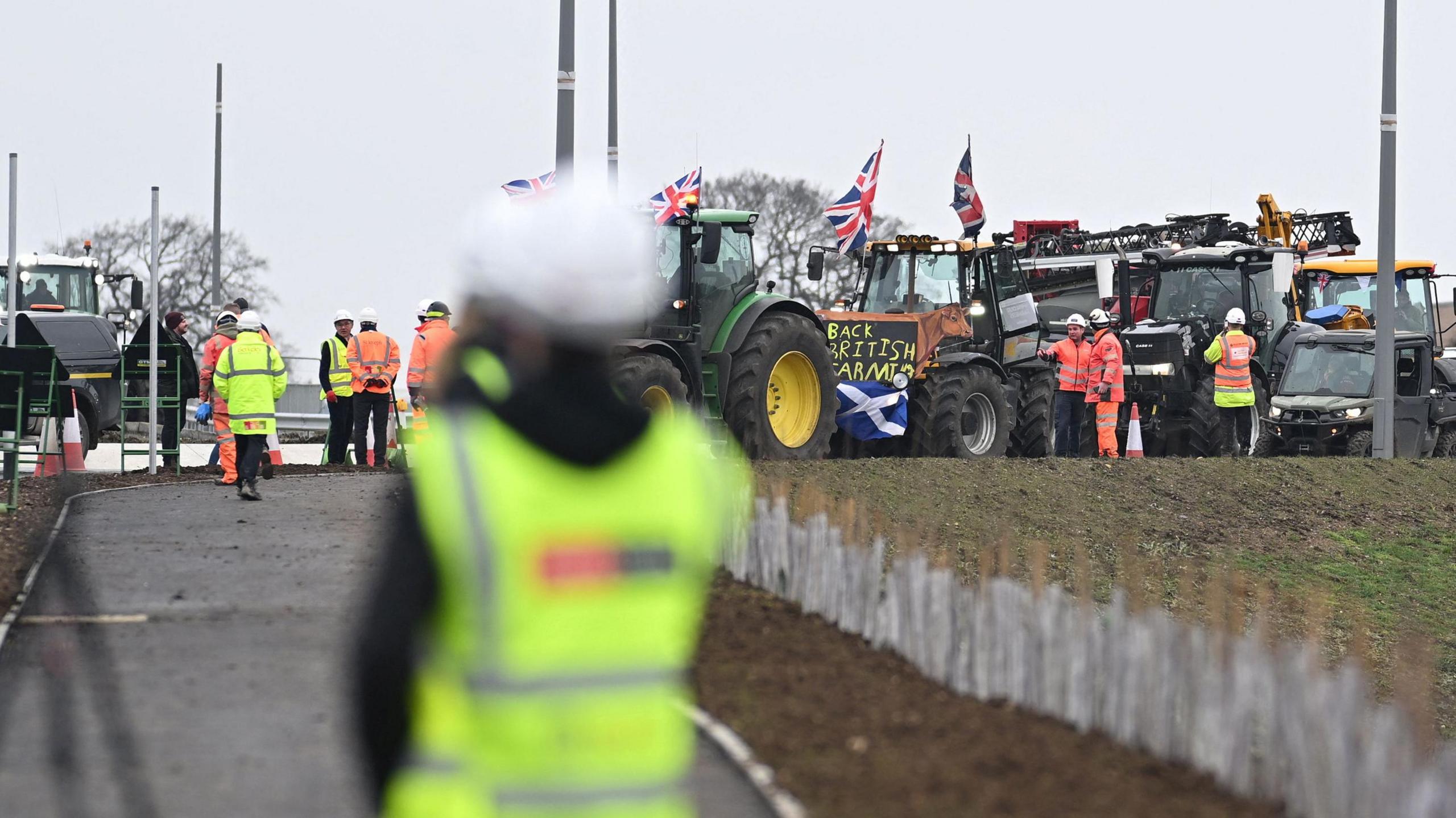 A protest takes place as British Prime Minister Keir Starmer visits a housing construction site