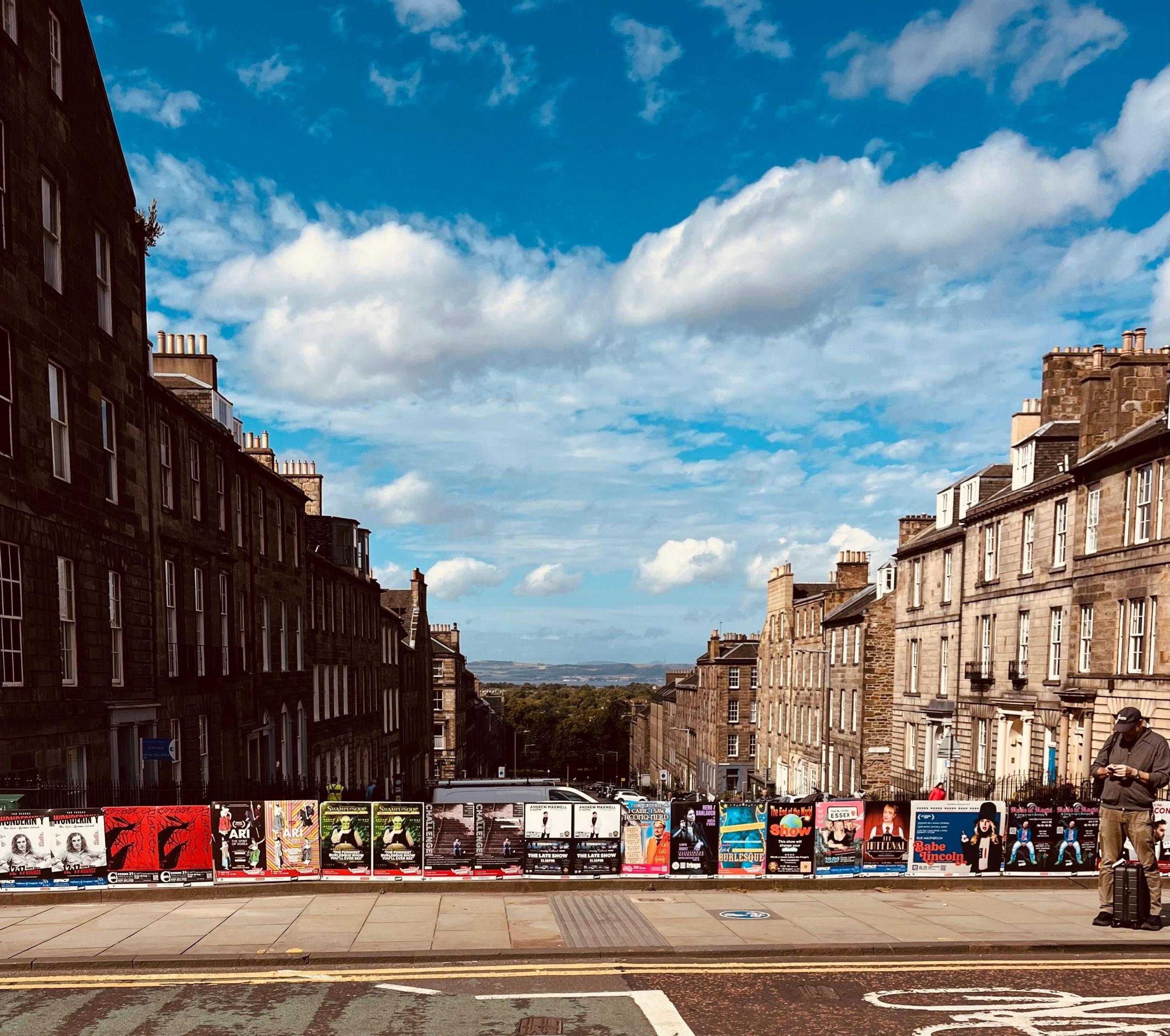 Dublin Street in the New Town of Edinburgh, looking downhill with blue skies and white clouds.