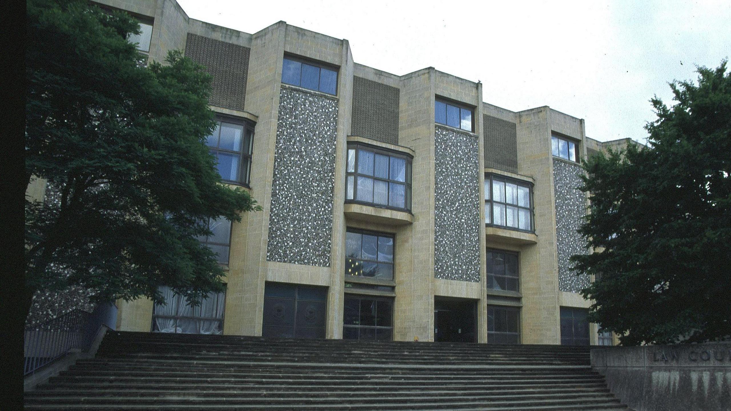 Winchester Crown Court building from the outside. It is a brown building with wide steps leading up to the entrance.