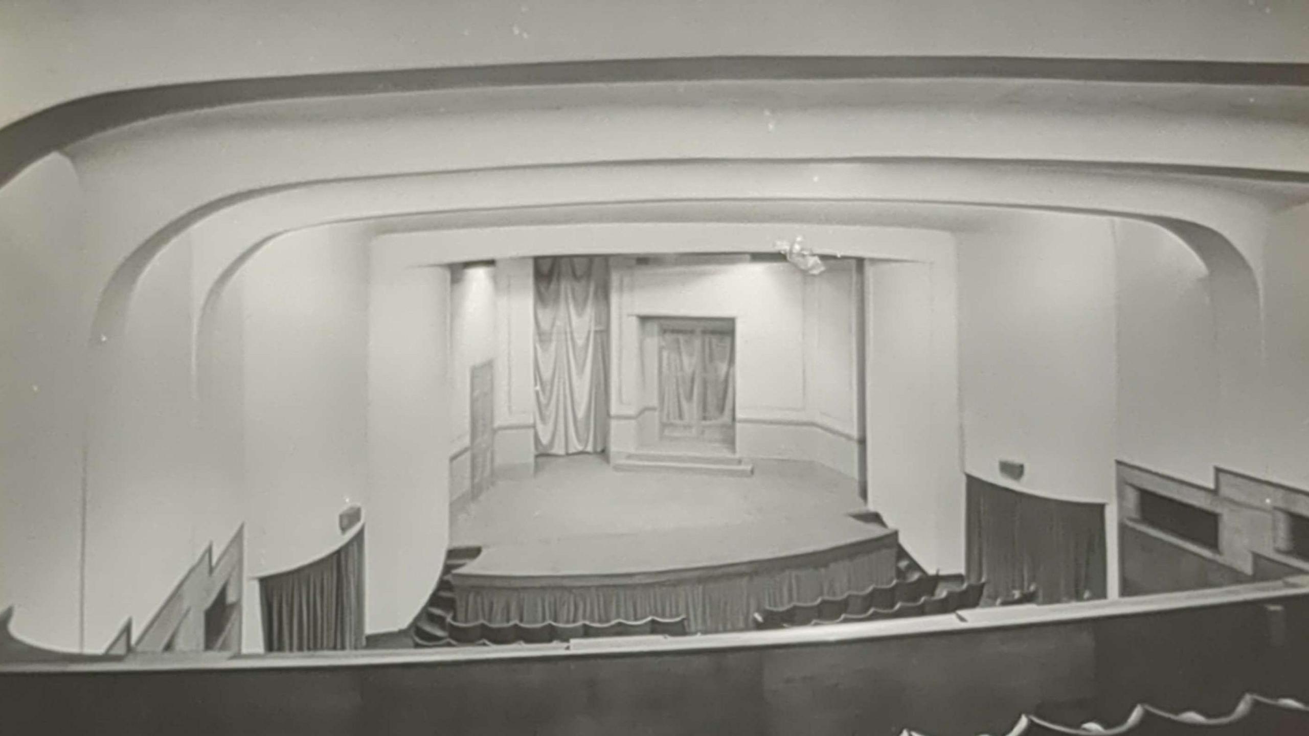 A black and white picture showing the stage of a theatre built in the art deco style in the mid 1930s