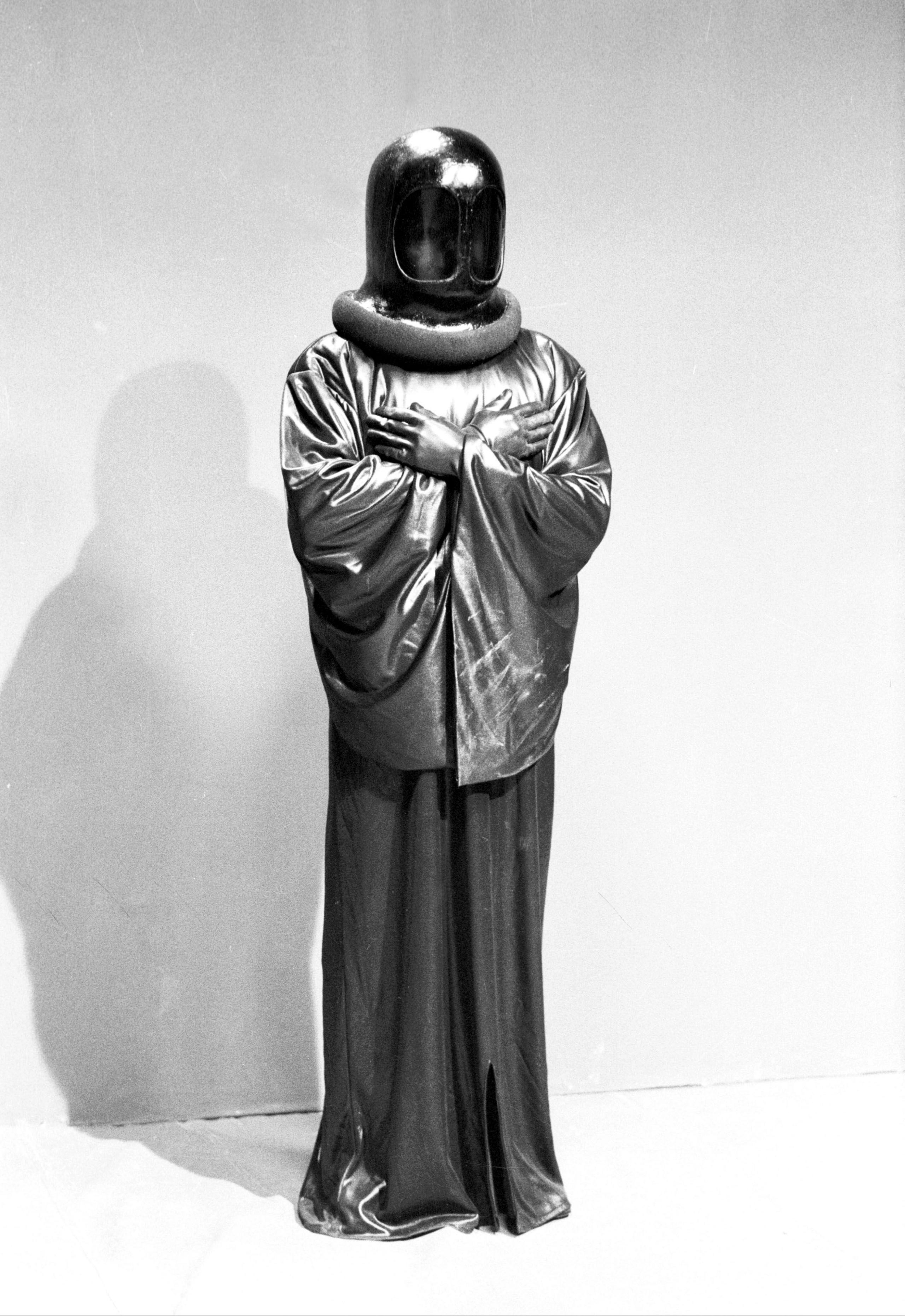 Full length black and white image of Sutekh in his robes and helmet