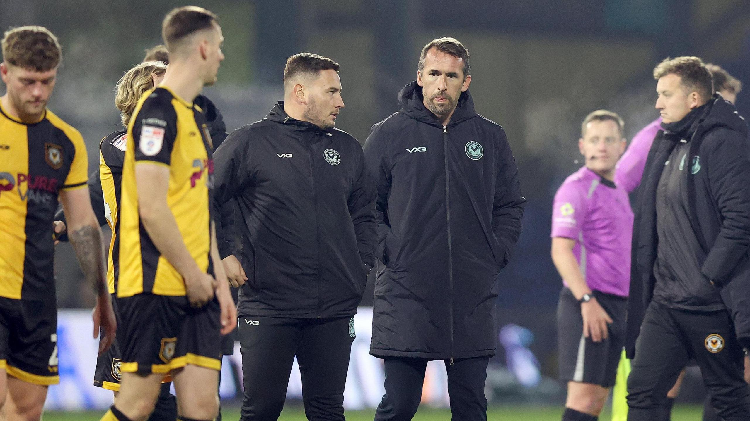 Newport boss Christian Fuchs gathers his players after defeat against Oldham in November 2025