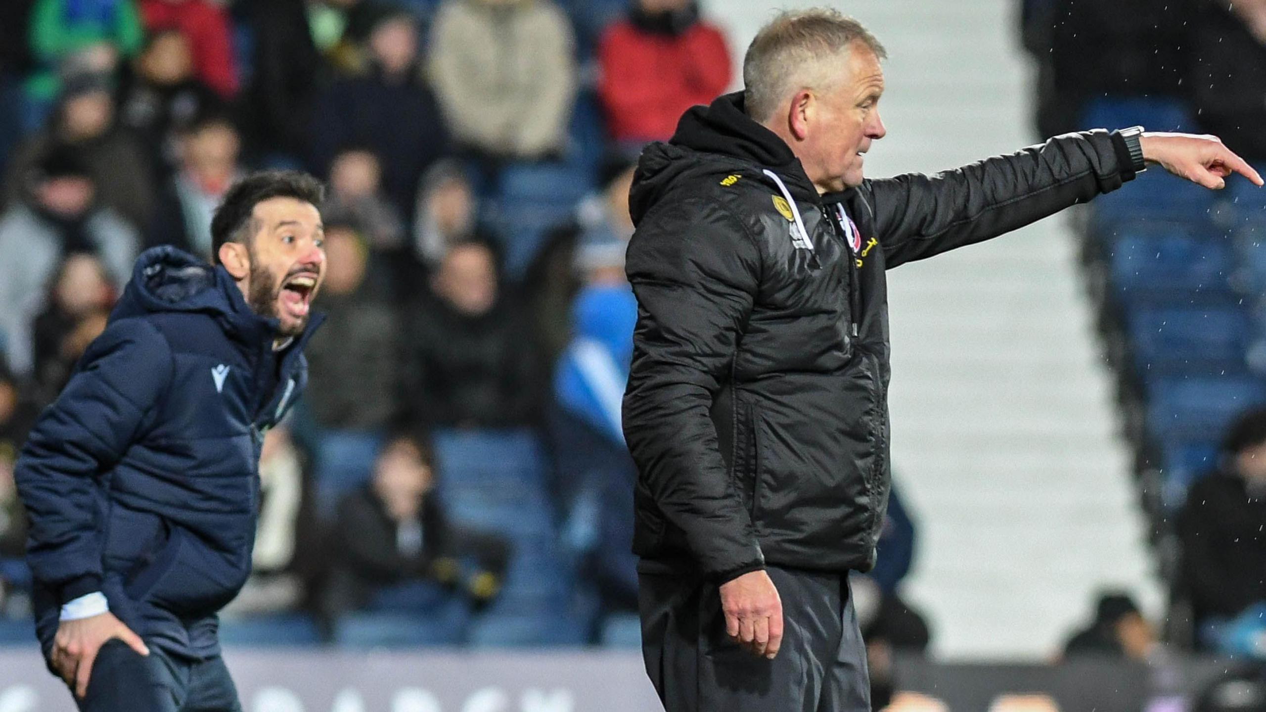 Carlos Corberan is shouting instructions from the touchline. Next to him is Sheffield United's Chris Wilder, pointing.