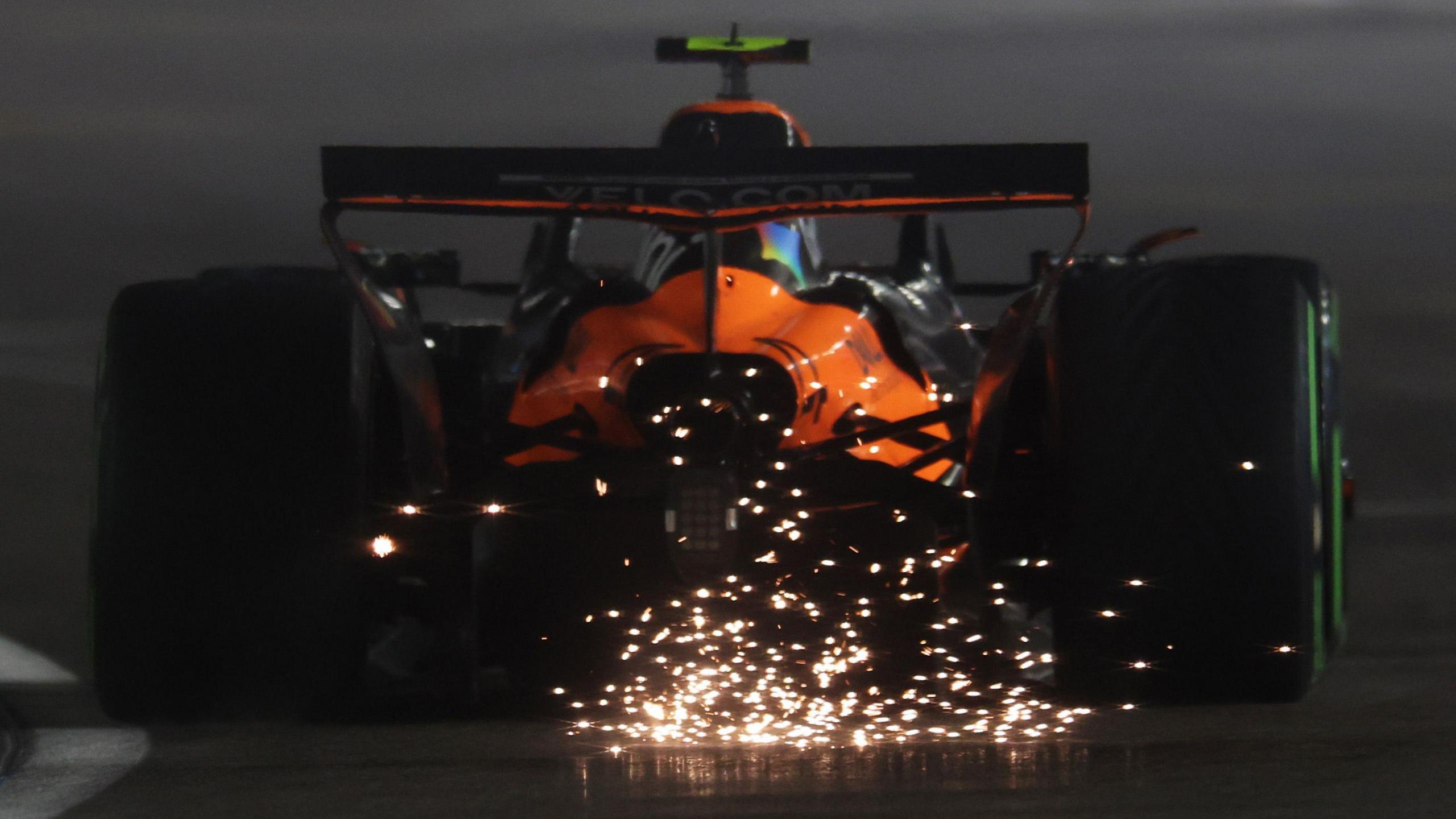 Sparks fly from the rear of Lando Norris' McLaren during final practice for the Las Vegas Grand Prix