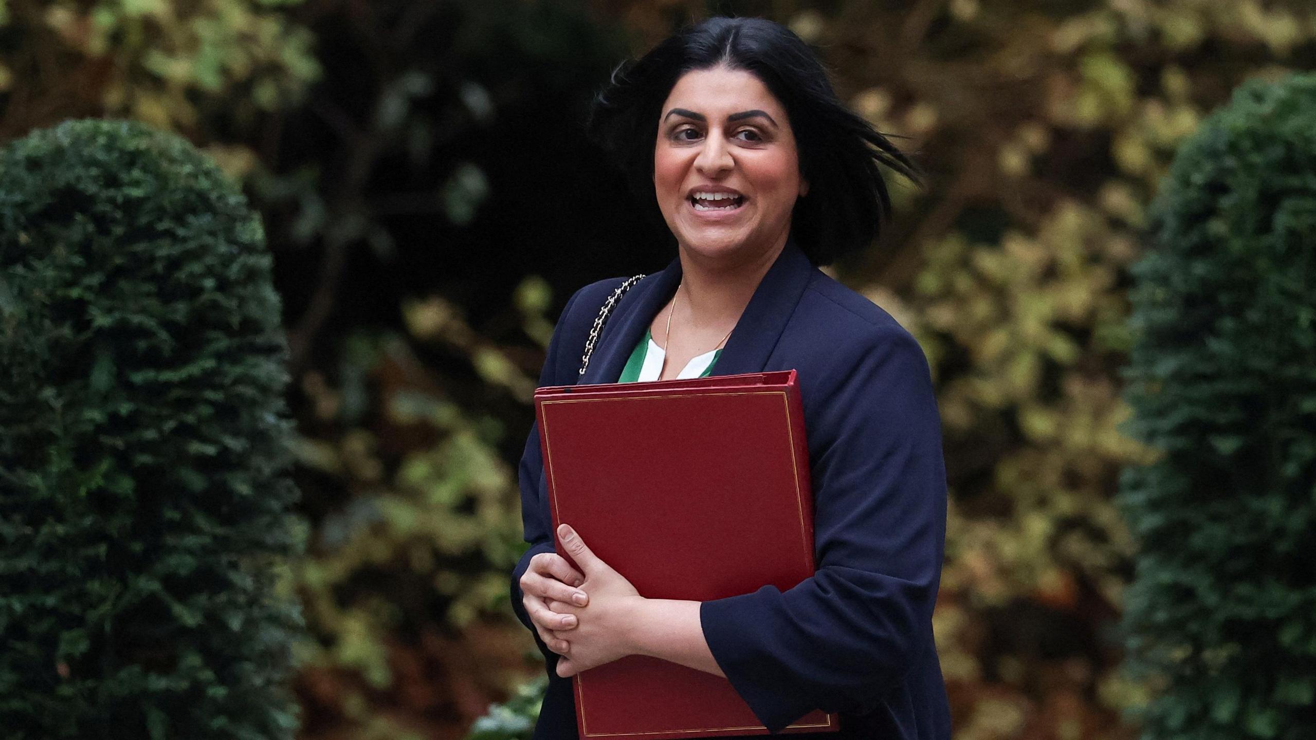 Home Secretary Shabana Mahmood walks outside Downing Street with a red binder
