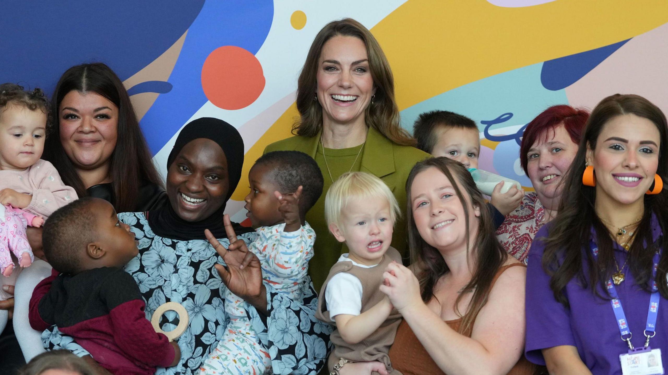 The Princess of Wales poses for a photo with families and volunteers during a visit to Home-Start Oxford.