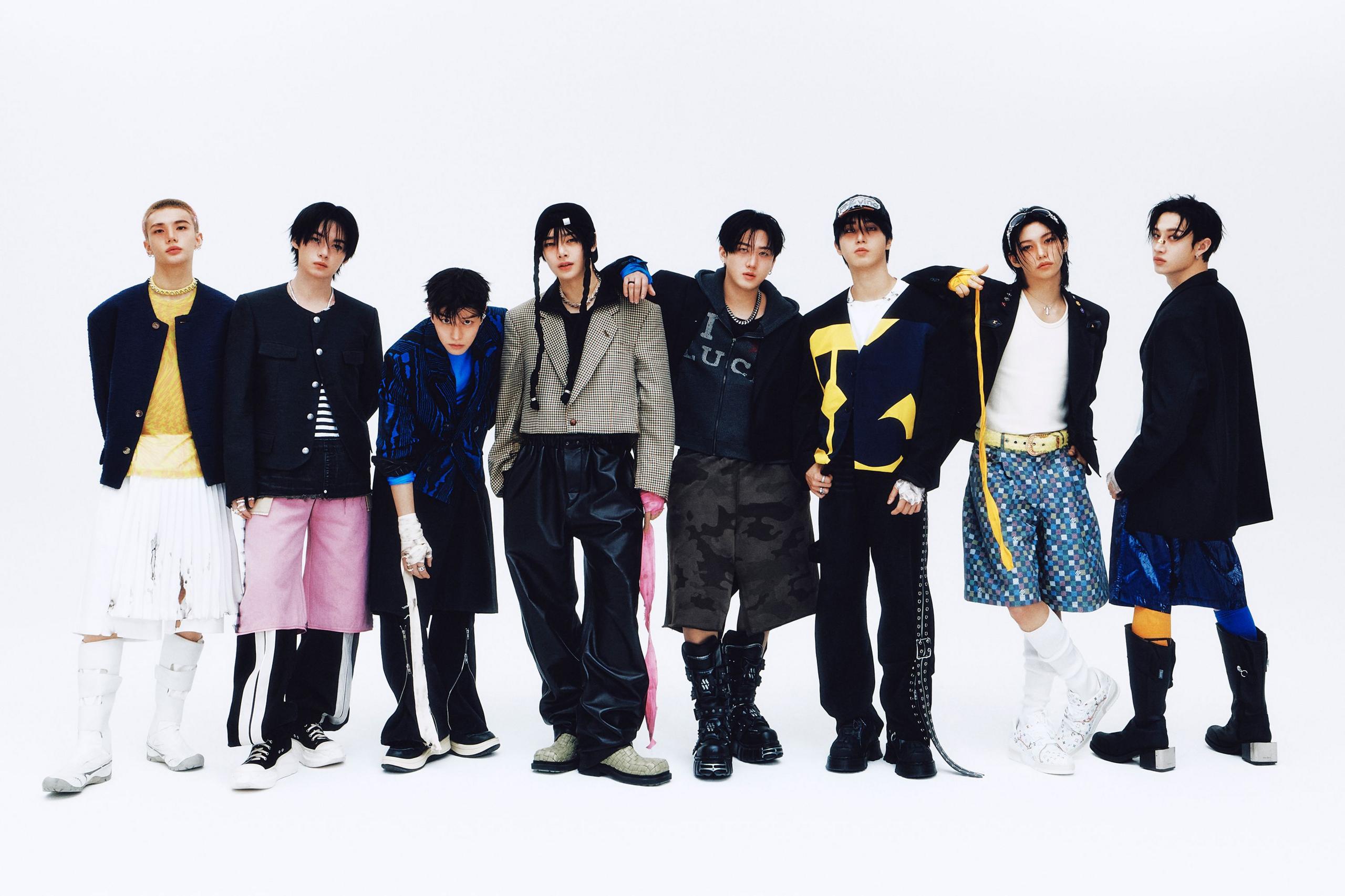 Promotional photo for Stray Kids, showing all members standing together against a white backdrop