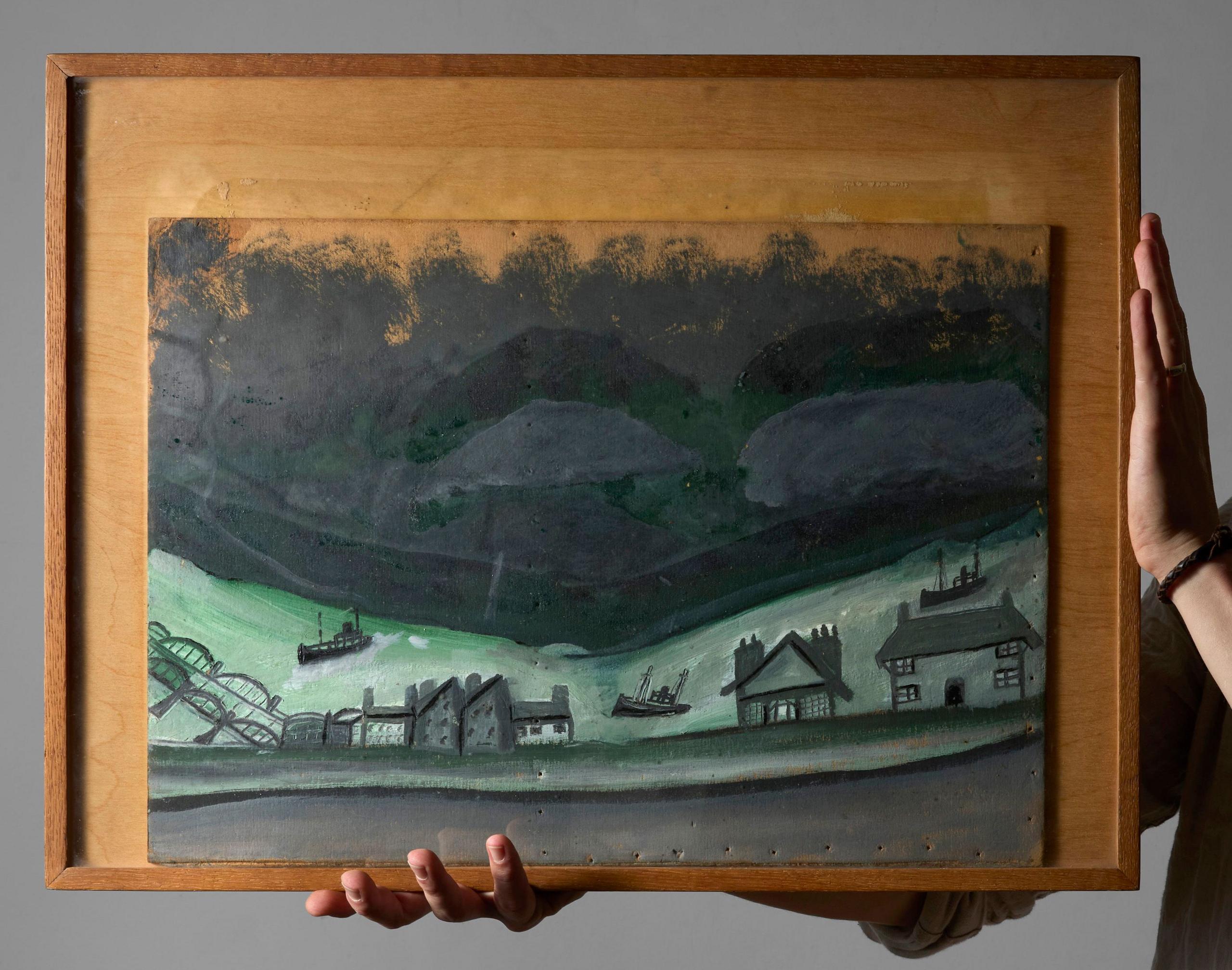 A semi-abstract painting of houses next to a river during a dark night with railway bridge arches in the bottom left. The main colours are teal and black or grey. It is in a wooden rectangular frame and is being held up by someone whose hands are pictured.