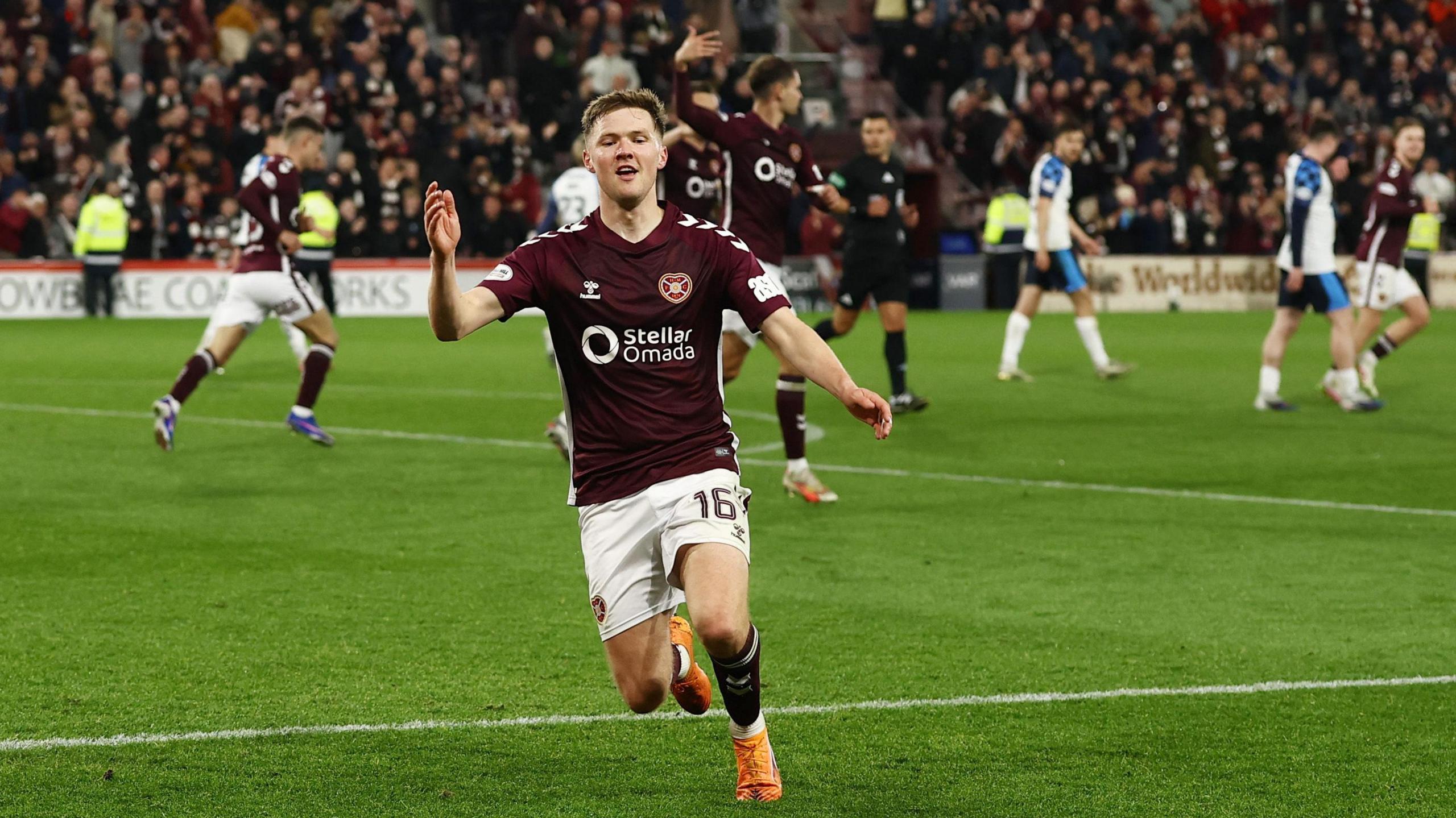 Blair Spittal celebrates scoring a late third for Hearts
